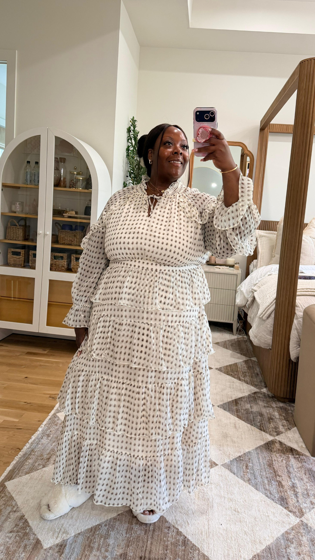 Feeling like a vision in white and black dots! 🖤✨ Obsessed with this stunning tiered maxi dress from EYWOL. It’s the perfect blend of classy and comfortable, and the ruffled details are just chef's kiss. I've paired it with my go-to white fuzzy slides for the ultimate cozy-glam look at home.

You can shop this exact dress and other favorites by following me on the LTK app! 🛍️

Follow for more @OPERATION_NIKI on IG, TikTok, & Facebook

#OOTD #EYWOL #MaxiDress #TiersOfJoy #PlusSizeFashion #CurvyStyle #LTKStyle #DailyLook #OutfitInspiration #ComfyChic #MirrorSelfie 

 #LTKootd #LTKMidsize #LTKPlusSize