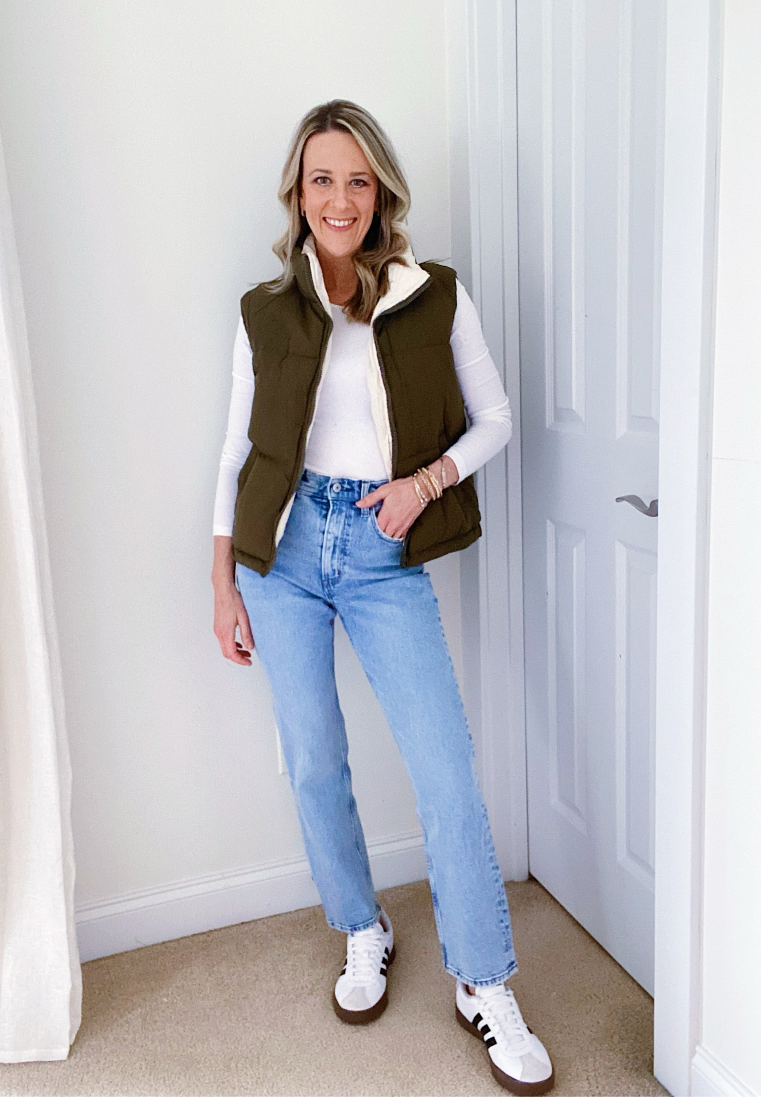 Errands Outfit

Fitted Long Sleeve Tee: H&M find. I am wearing an XS in this closet basic for a tighter fit. For a more relaxed fit, size up two. 
Crop Puffer Vest: Amazon Find. Wearing a size S. It comes in a lot of great neutrals to make it versatile with whatever outfit you’re planning. 
Jeans: Abercrombie's Ultra High Rise Ankle Straight Jeans. I'm 5'4" with a longer torso and shorter legs, wearing the the 25r. If you're under 5’4”, snag the short  I find these jeans fit TTS except the black wash. Size up, they have a bit less stretch.

Adidas: These are the Adidas Courts (TTS). They are a great option if you love the look of Sambas but not the price point. These are about $40-$50 less.

Elevated Mom Style | Nursing Friendly Outfit | Mom Outfit | Affordable Winter Fashion | Amazon Fashion | Straight Leg Jeans | Sambas Outfit 

#LTKfindsunder100 #LTKstyletip #LTKfamily