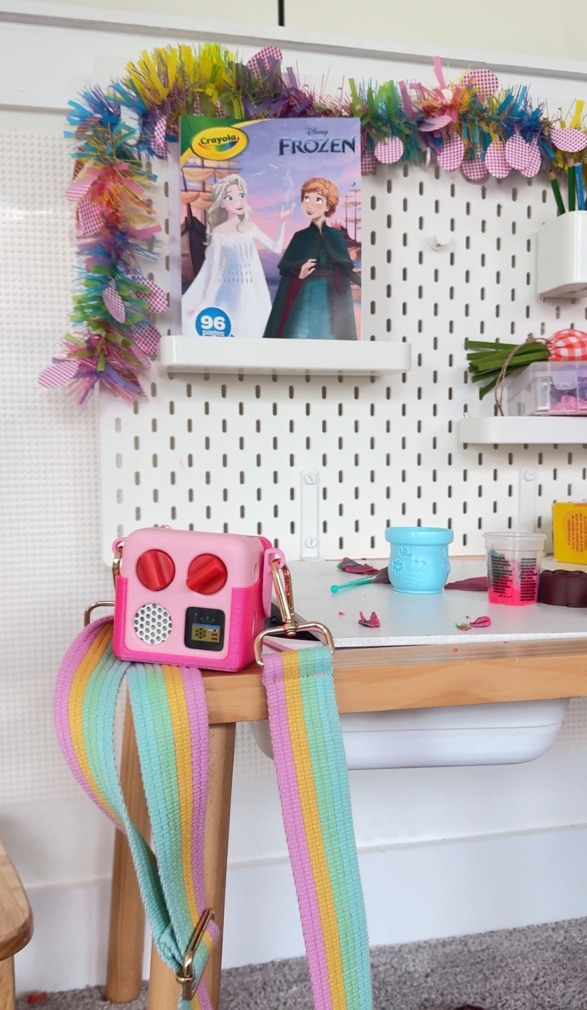 Yoto mini player with the case that allows us to put a crossbody strap on it! 