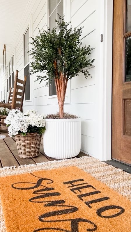 Front porch and front door decor large white fluted planter trending viral home decor pottery barn dupe look a like look for less artificial faux plants trees flowers florals greenery faux geraniums hydrangeas doormat and jute scatter rug layered double modern farmhouse southern porch eucalyptus tree

#LTKstyletip #LTKSeasonal #LTKhome