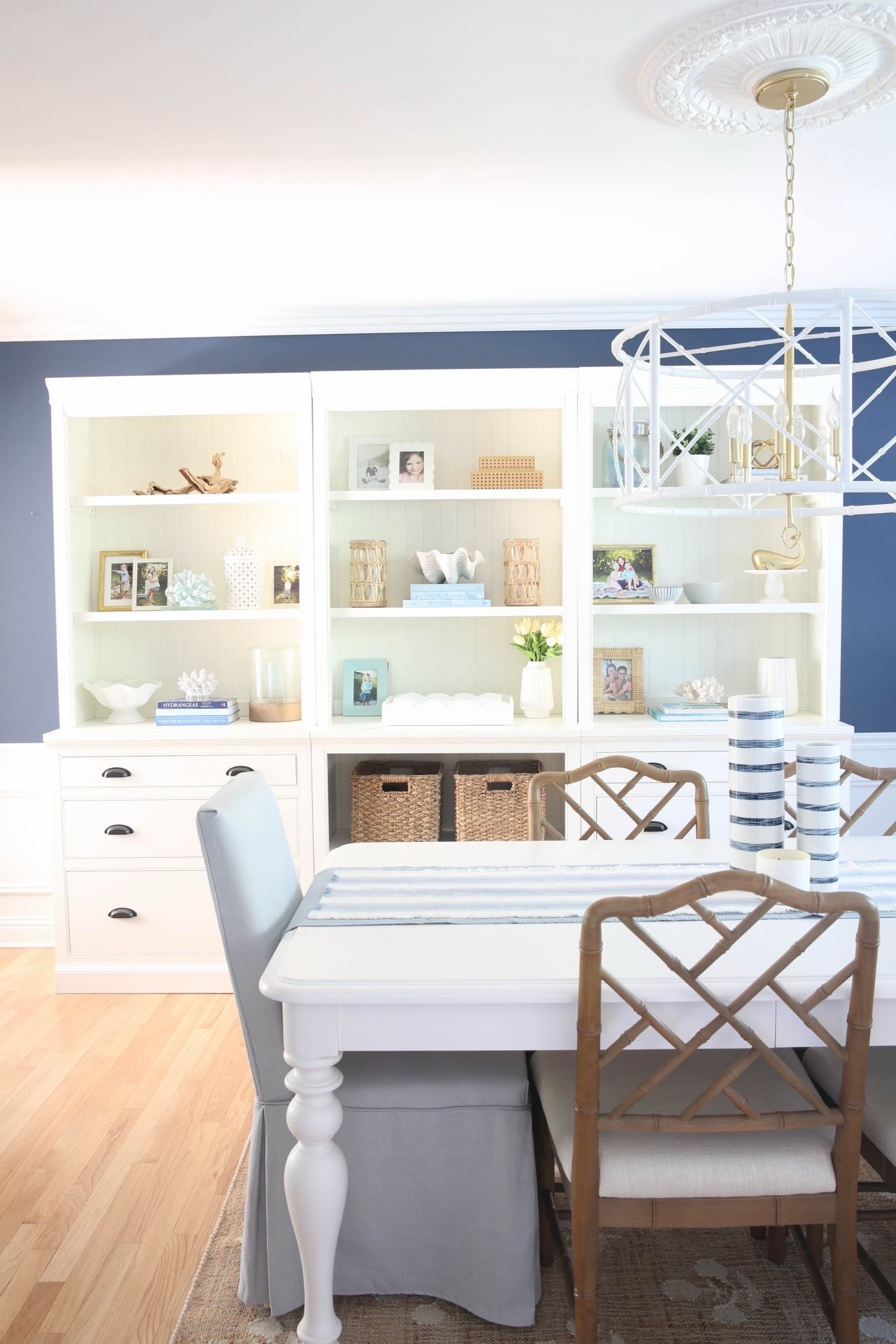 This coastal dining room with blue walls, a white bookshelf, and curated coastal accents is bright, beachy, and full of designer-inspired style. I love how the deep blue paired with crisp white furniture and seaside decor makes every meal feel elevated and relaxed. 



#LTKHome #LTKSaleAlert #LTKU