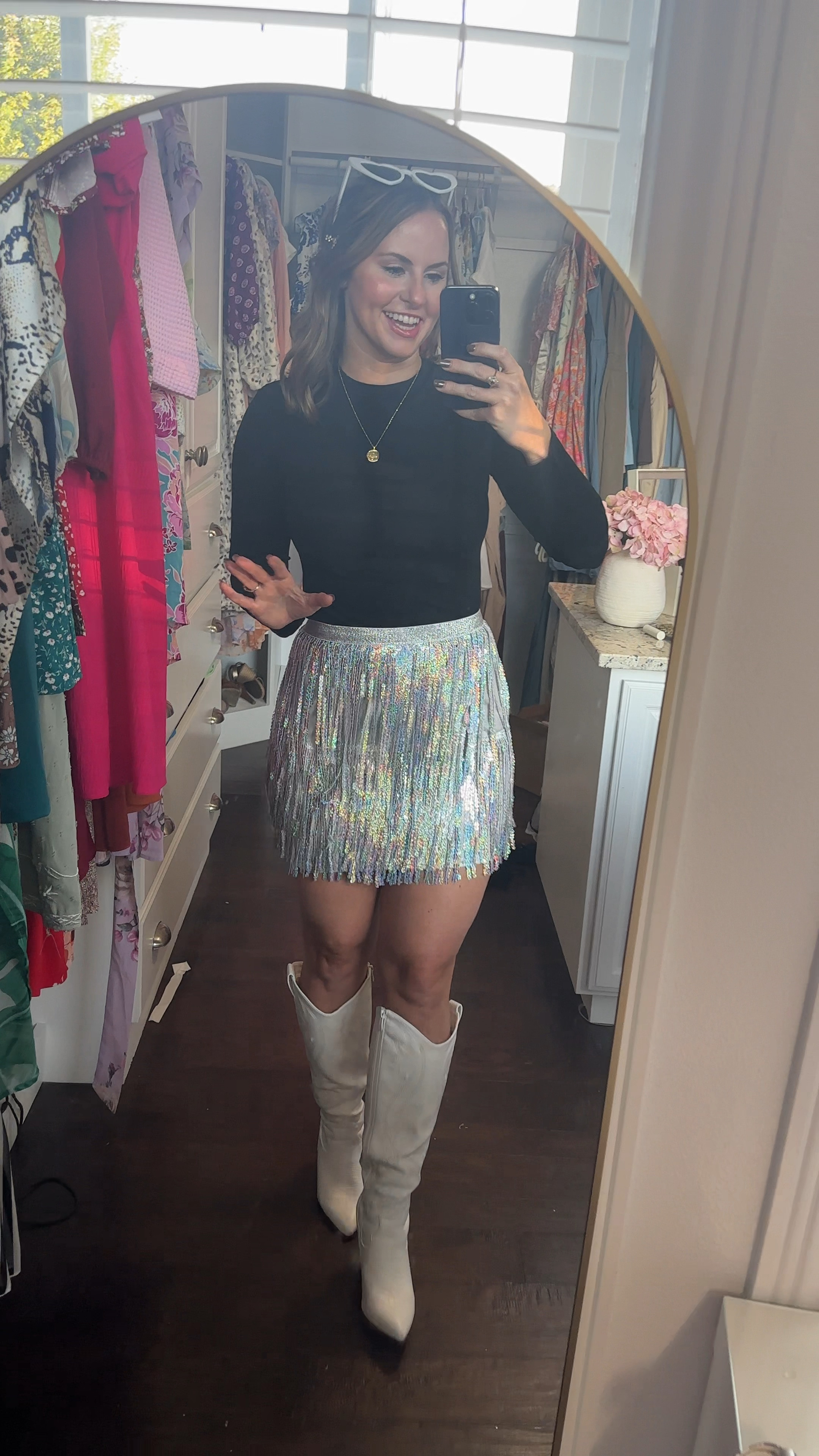 Fun concert or Vegas outfit! This sequin fringe skirt is SO adorable! It’s stretchy and also has a zipper in the back. It’s high waisted and has elastic waist band. Paired it with this black top that gives the look of a bodysuit, white cowboy boots, heart sunglasses & sparkly hair clips. 

Eras tour outfit, Meghan trainor concert outfit, Taylor swift outfit , Halloween costume, fall outfit, Las Vegas dress , fringe skirt 

#LTKStyleTip #LTKFindsUnder50 #LTKVideo