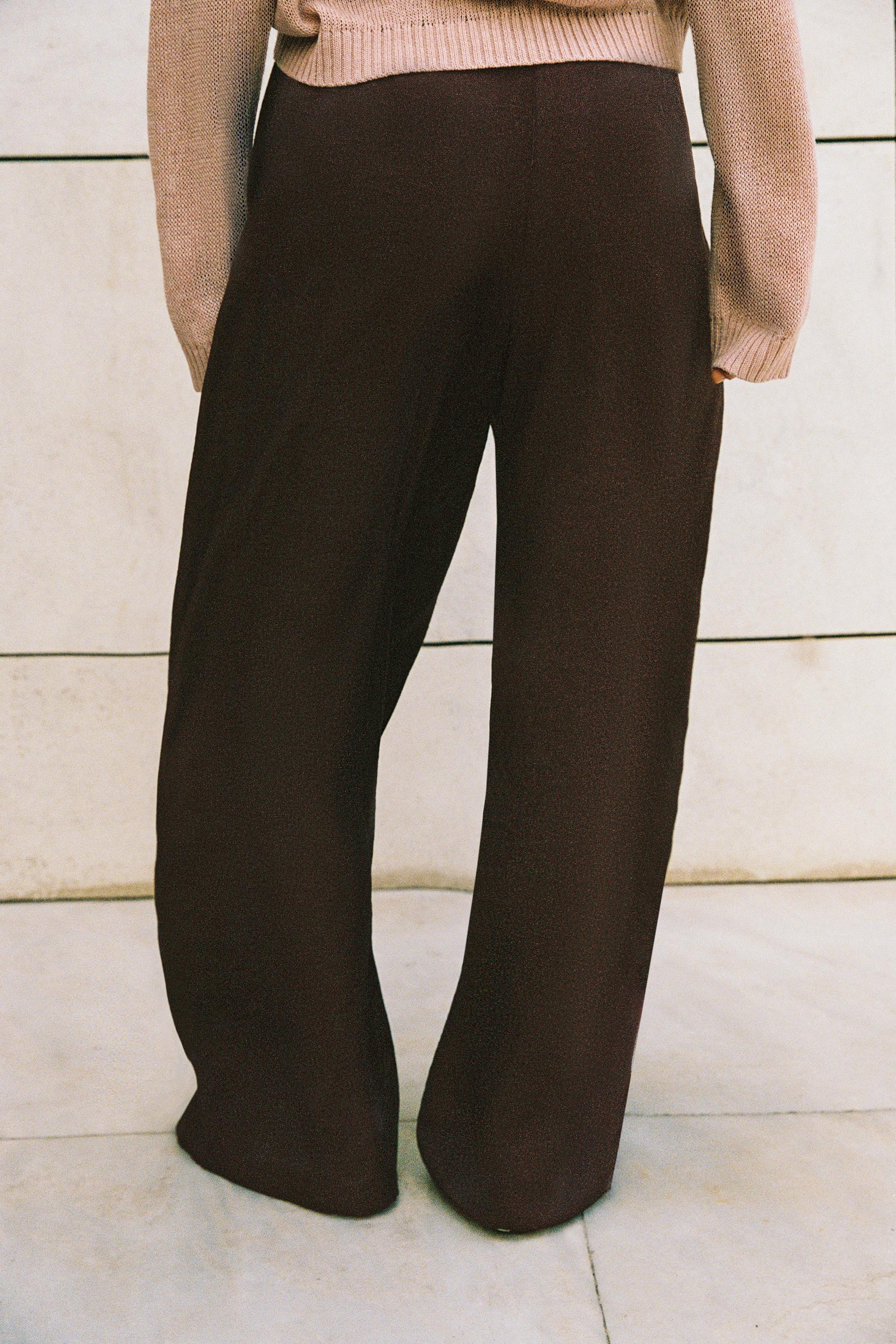 Model height: 177 cmHigh-waisted satin trousers with front pleats. Front pockets. Belt detail. Wi... | Zara US