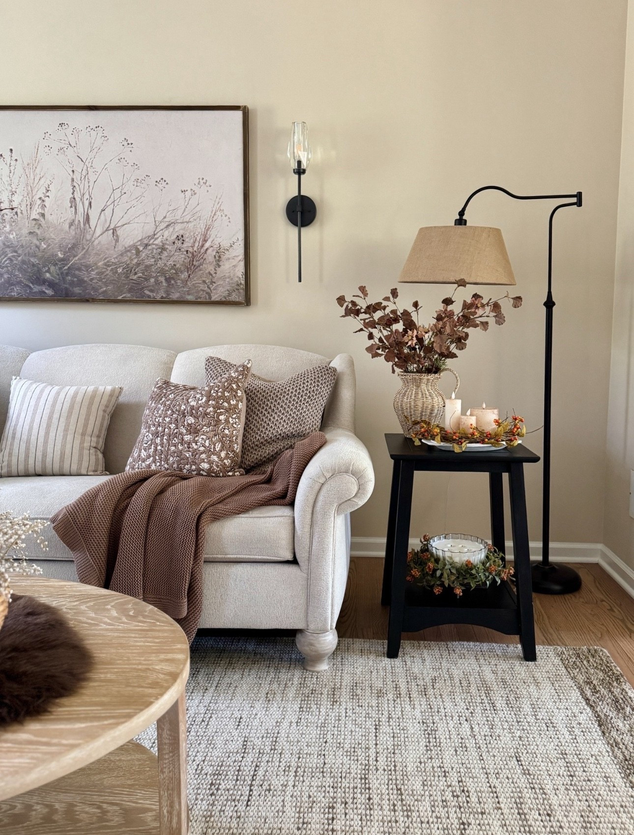 Shop our living room and one of my favorite corners in our home! This solid wood end table comes unfinished so you can stain or paint it any color you want and is at a great price. I first painted mine white and now it’s black. It is solid wood and excellent quality and is now 45% off! Also sharing my beloved curved floor lamp with linen shade that’s back in stock and on sale! Also sharing the pretty solid wood custom made wall art and beautiful crystal wall sconces. One of my favorite and so reasonably priced rattan vase, some pretty neutral stems, neutral pillow covers and dark brown faux fur rug that I use as a table runner throughout the winter.

#LTKSaleAlert #LTKHome