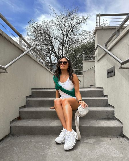 Casual active Athleisure outfit with tennis dress, green sweatshirt, white headband, oversized sunglasses, and white sneakers

#LTKfit #LTKtravel #LTKSeasonal