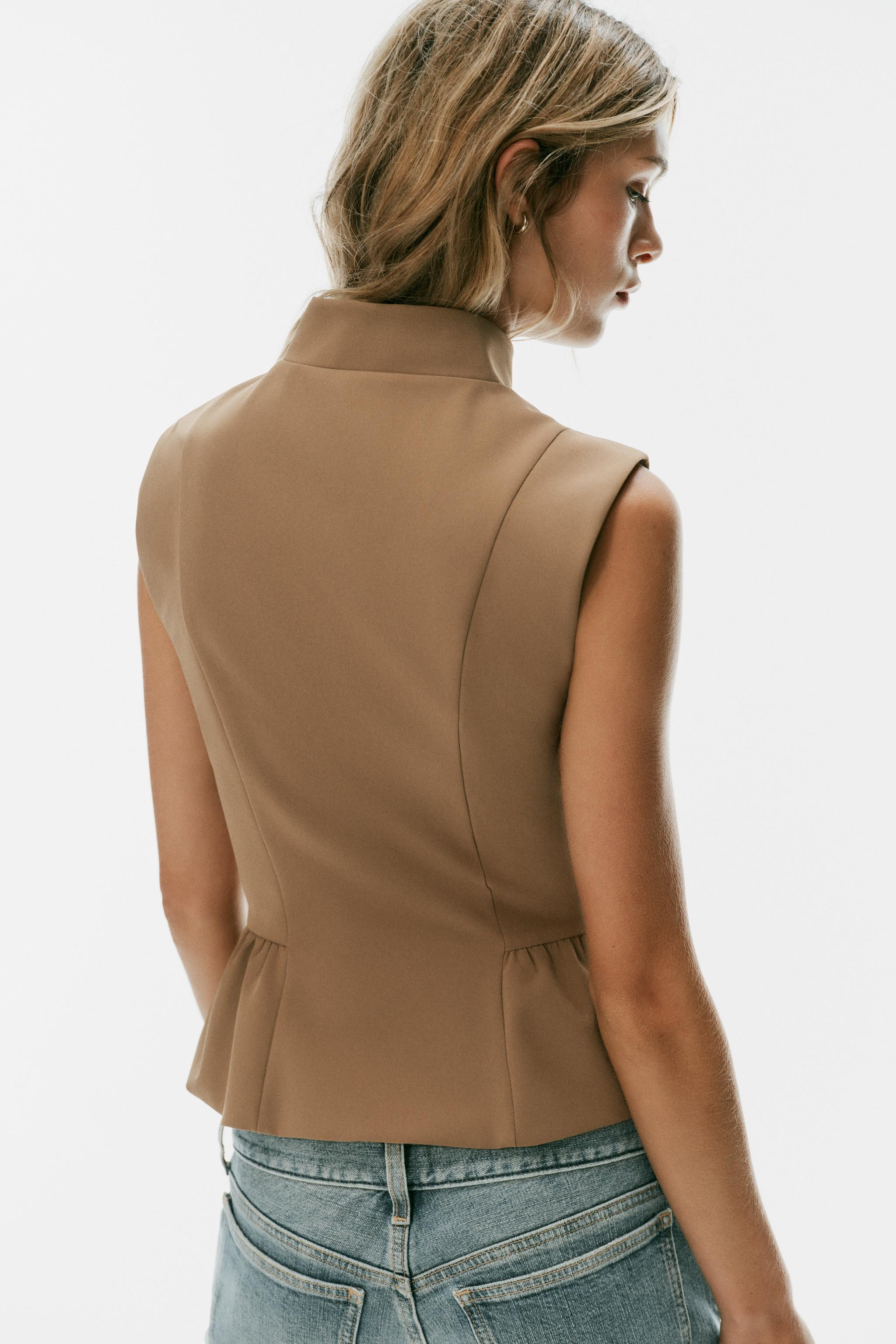 High-neck, sleeveless top. Features a matching tone-on-tone lining, a peplum hem, and a double-br... | Zara US