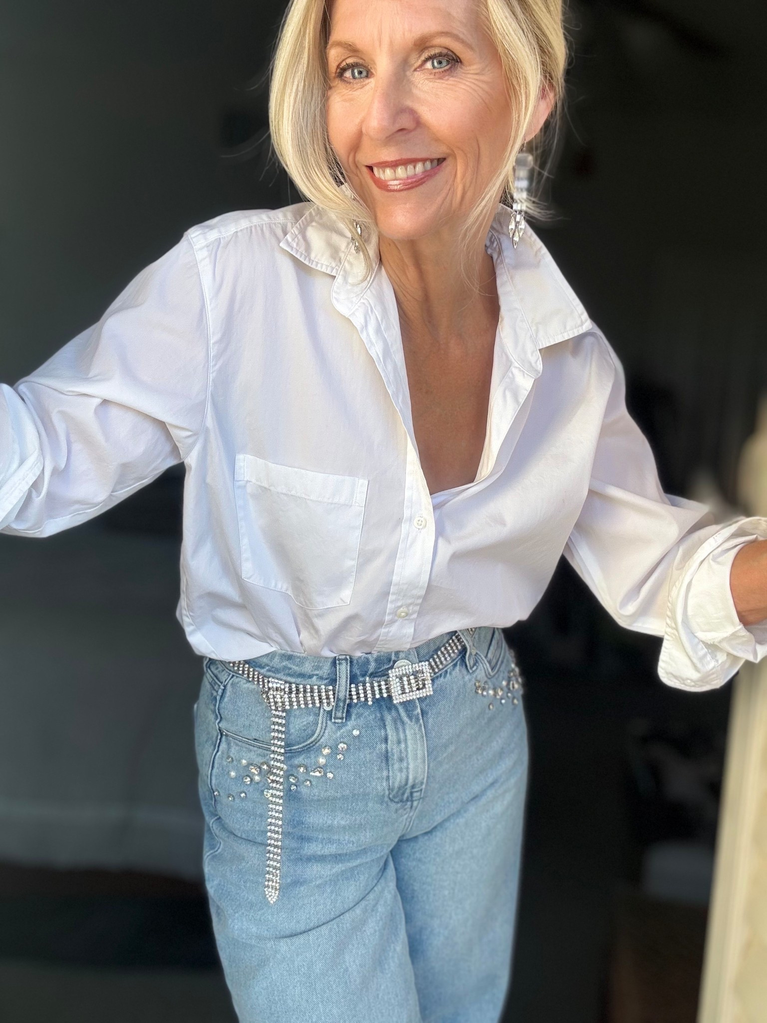 I think I might be addicted to this…

Rhinestones are ruling my wardrobe lately and who doesn’t love a crisp white blouse to go with them!

This is a simple and easy outfit to put together in the month of December and I think it would be fun for New Year’s Day.

There’s so many variations on these rhinestone jeans that I will link them for you. My blouse is my favorite @frankandeileen 

Follow me for more 50+ holiday style inspiration.



#LTKOver40 #LTKHoliday