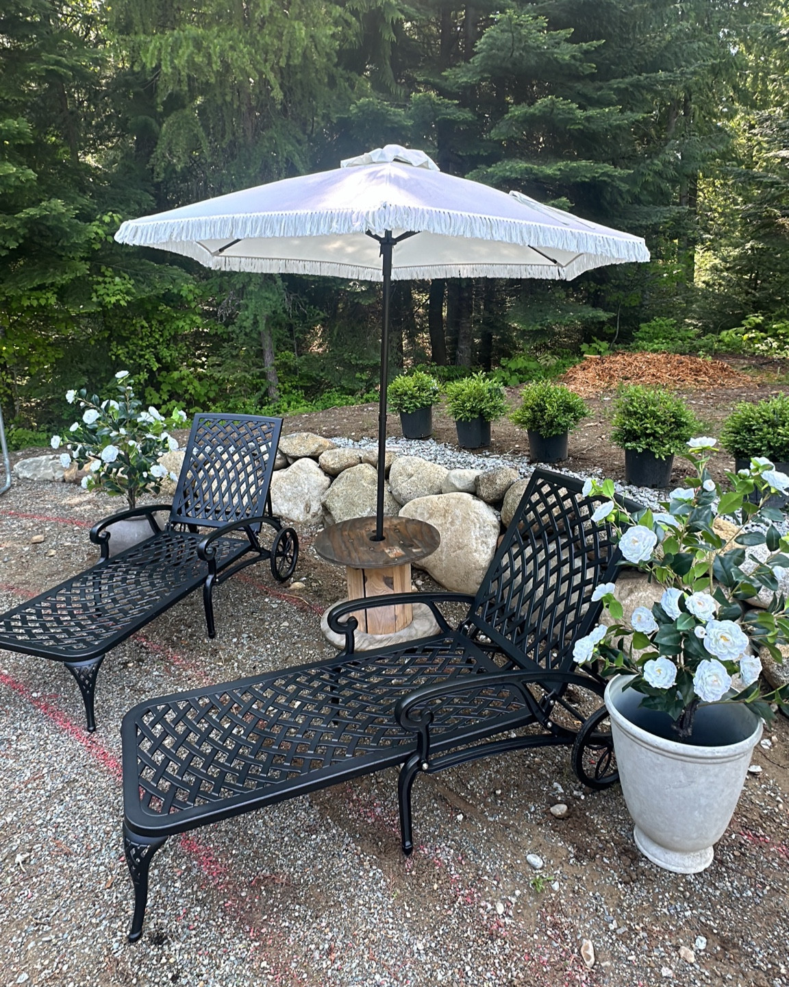 Outdoor patio decor, metal lounger , fringe umbrella, stone planter and faux flowers

#LTKStyleTip #LTKSaleAlert #LTKSeasonal