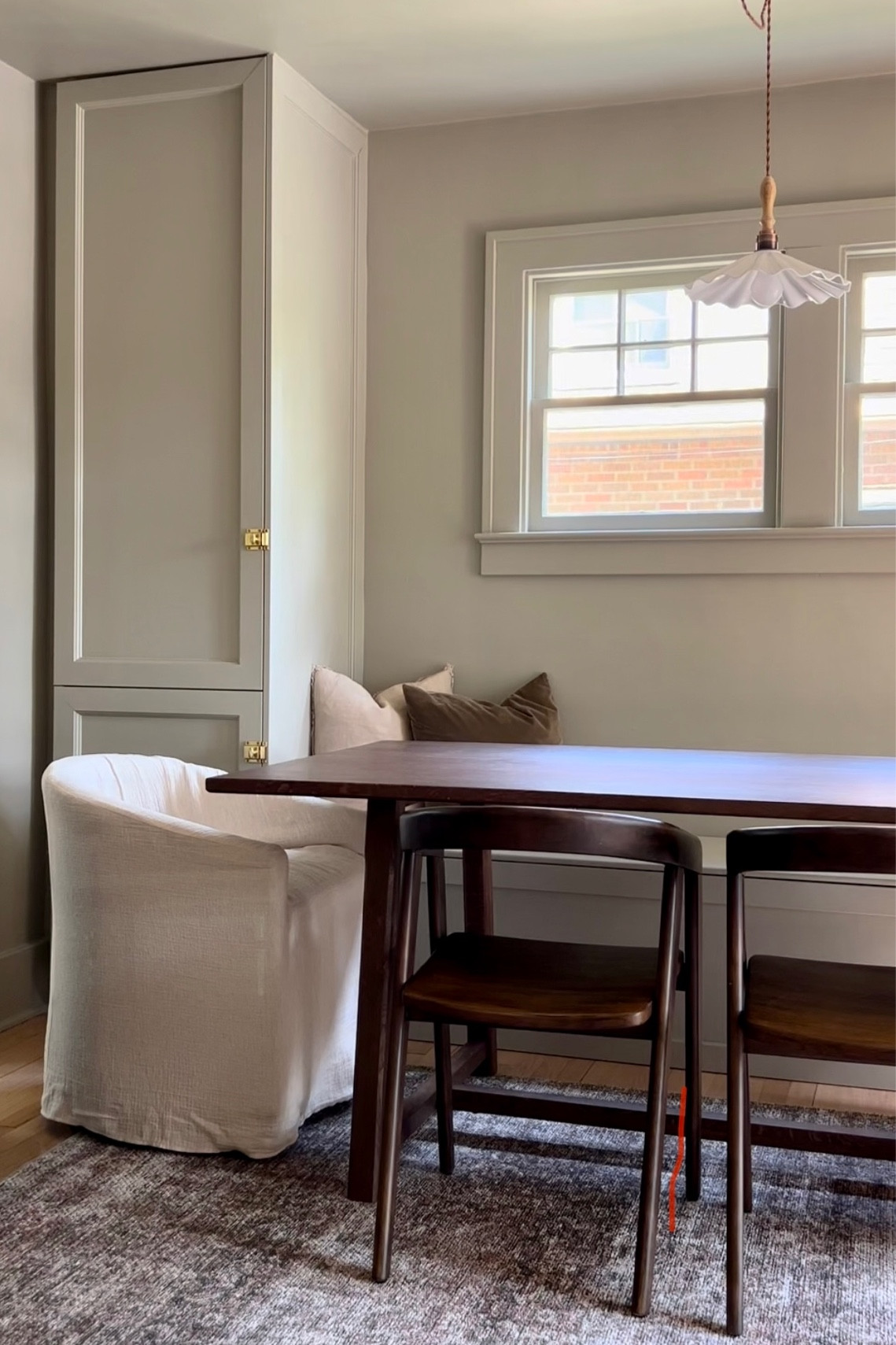 Cozy dining room with large dark wood dining table, dark wood dining chairs, and upholstered barrel back chairs. #diningroom #diningroomfurniture #diningtable #diningchairs

#LTKhome