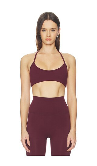 Astoria Halter Sports Bra in Burgundy. - size S | Revolve Clothing (Global)