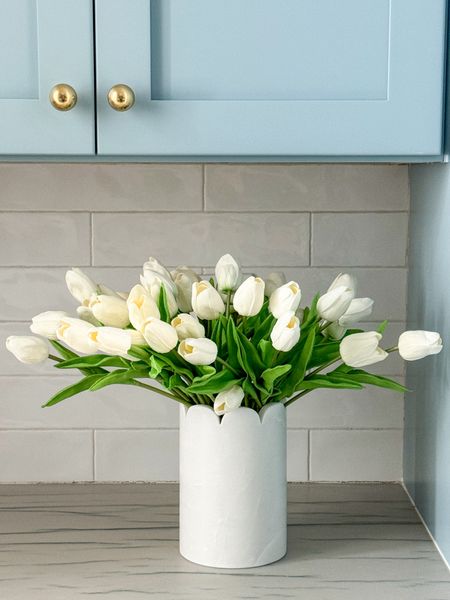 My favorite faux real-touch tulips for spring! I have two sets here for a dramatic look but one set works in most smaller vases! Here I paired it with a scalloped marble wine chiller in our pantry. Also linking our brass cabinet knobs!
.
#ltkhome #ltkfindsunder50 #ltkseasonal #ltkstyletip #ltkfindsunder100 #ltksalealert Amazon home finds, spring kitchen decor, coastal decor 

#LTKSeasonal #LTKsalealert #LTKfindsunder50