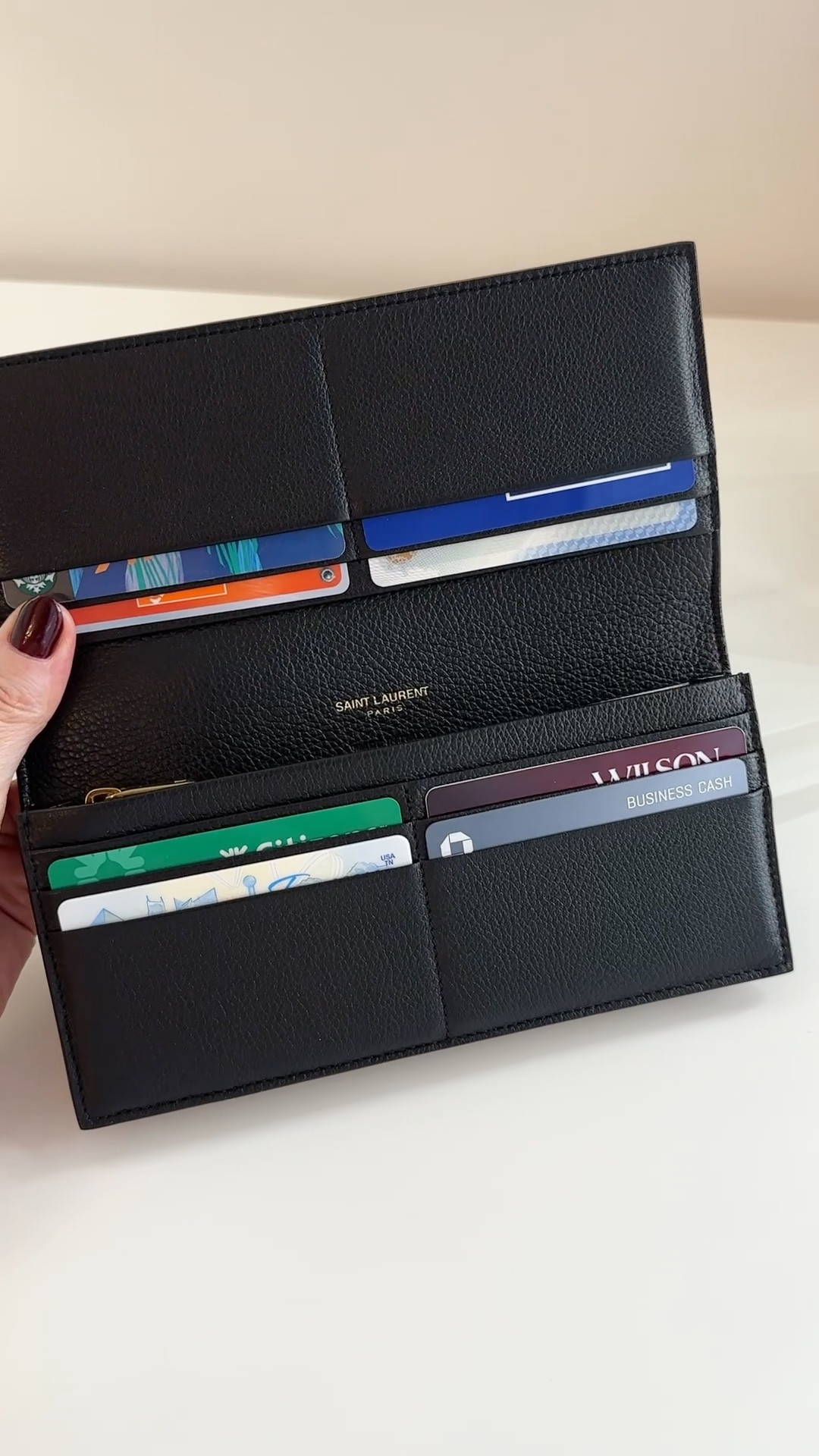 I’ve had this black Saint Laurent Tiny Cassandre Flat Wallet for over a year & carry it exclusively.✨

It’s my favorite wallet…ever! I love that the bills slide easily into the filer section & there is no exterior zipper or extra added weight. Very large coin compartment with a smooth & rich zipper 😮‍💨

#LTKItBag #LTKStyleTip #LTKTravel