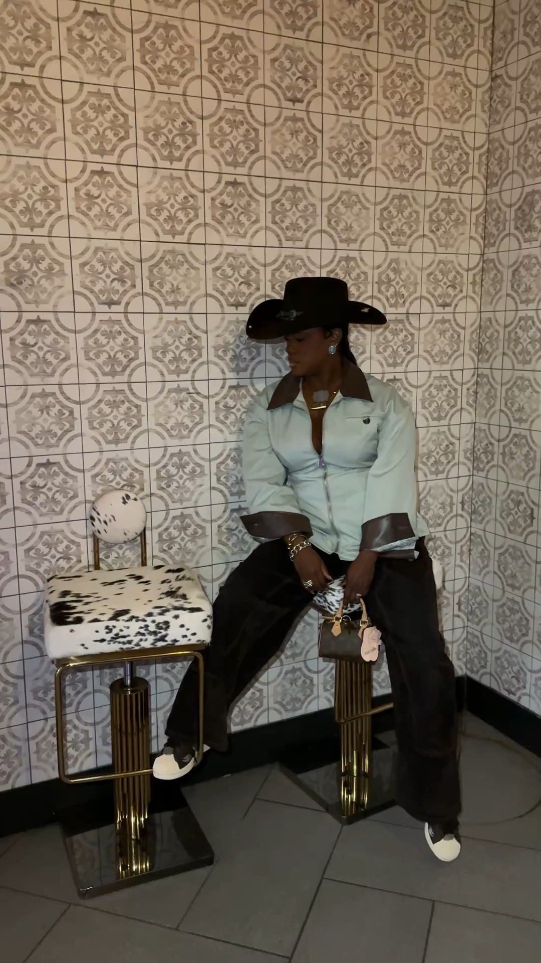 Western inspired outfit with cinched jacket and brown velvet pants 