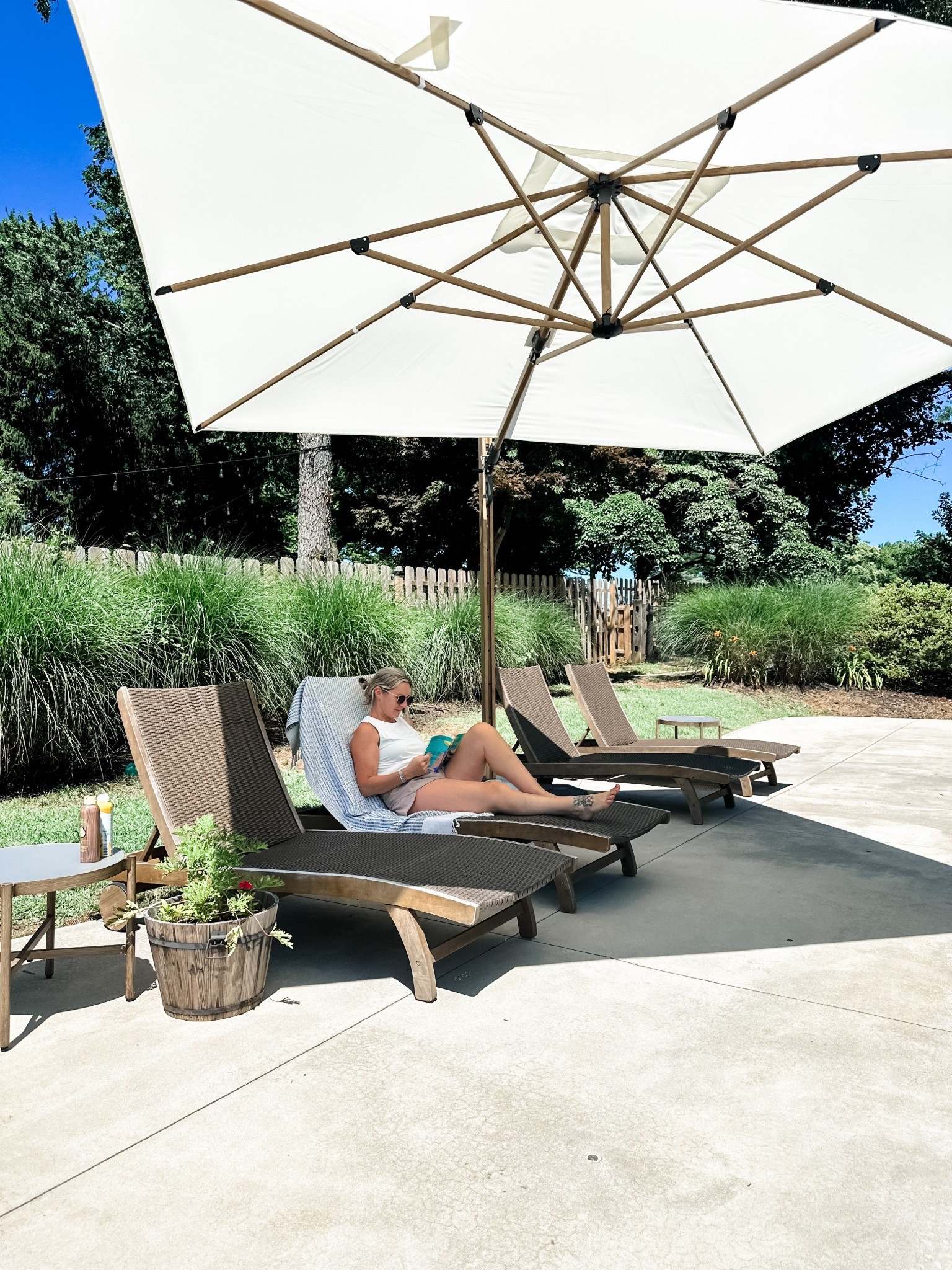 If you’re looking for lounge chairs that are comfy but don’t have cushions…these are great. There’s a tray that slides out from underneath from side to side for your things, the backs are adjustable and lay all the way down and the wheels are functional and aesthetic. They are teak so I’d recommend oiling them every so often to bring them back to life. They’ve served us well for the last 4 years! This umbrella is wildly convenient too! 

#LTKdayinmylife #LTKSeasonal #LTKHome