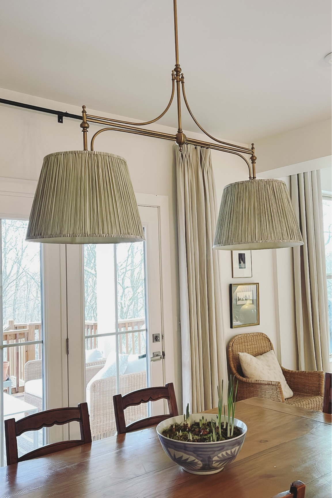Our Dining Room - we paired the Ballard Designs light fixture with pleated lampshades from Pooky Lighting. Our dining room table is old from World Market, chairs are vintage. Linking similar options! ------
traditional home, classic home styling, Southern home, farmhouse, ladder back chairs, vintage, pleated lampshade, blue and white, Ballard Designs 

 #LTKHome