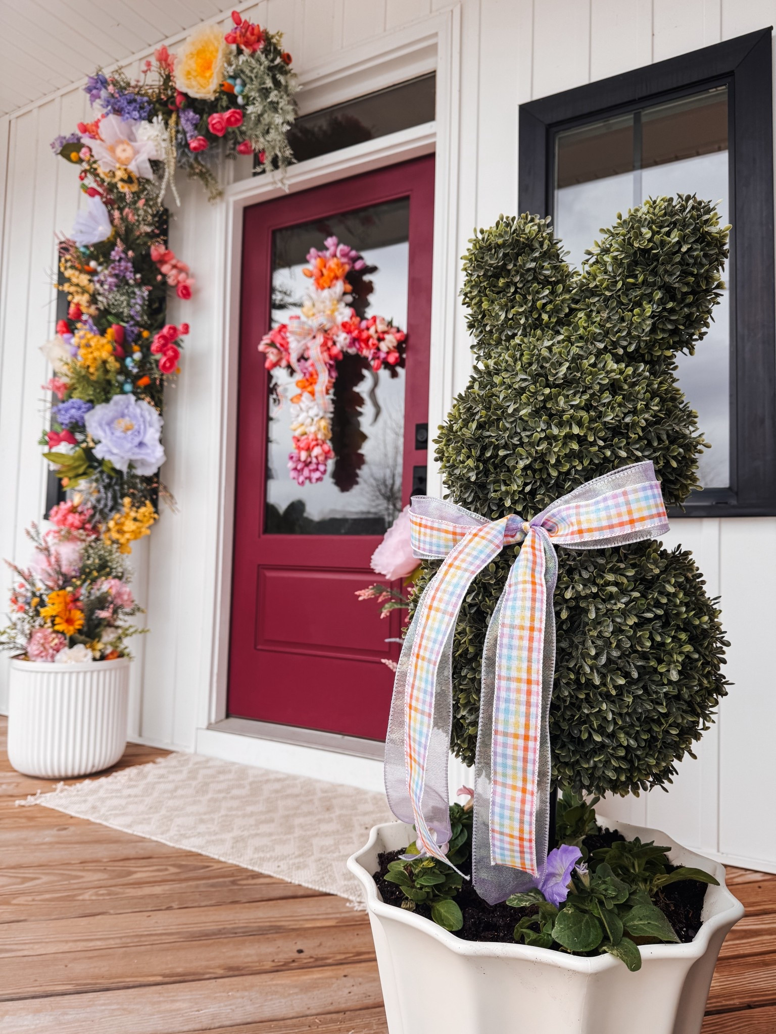my Easter front porch featuring a spring flower install. Used my bunny topiaries from last year. Added some ribbon and flowers around the base. I love it paired with my Easter tulip wreath #springdecor #easterdecor

#LTKHome #LTKSpringSale