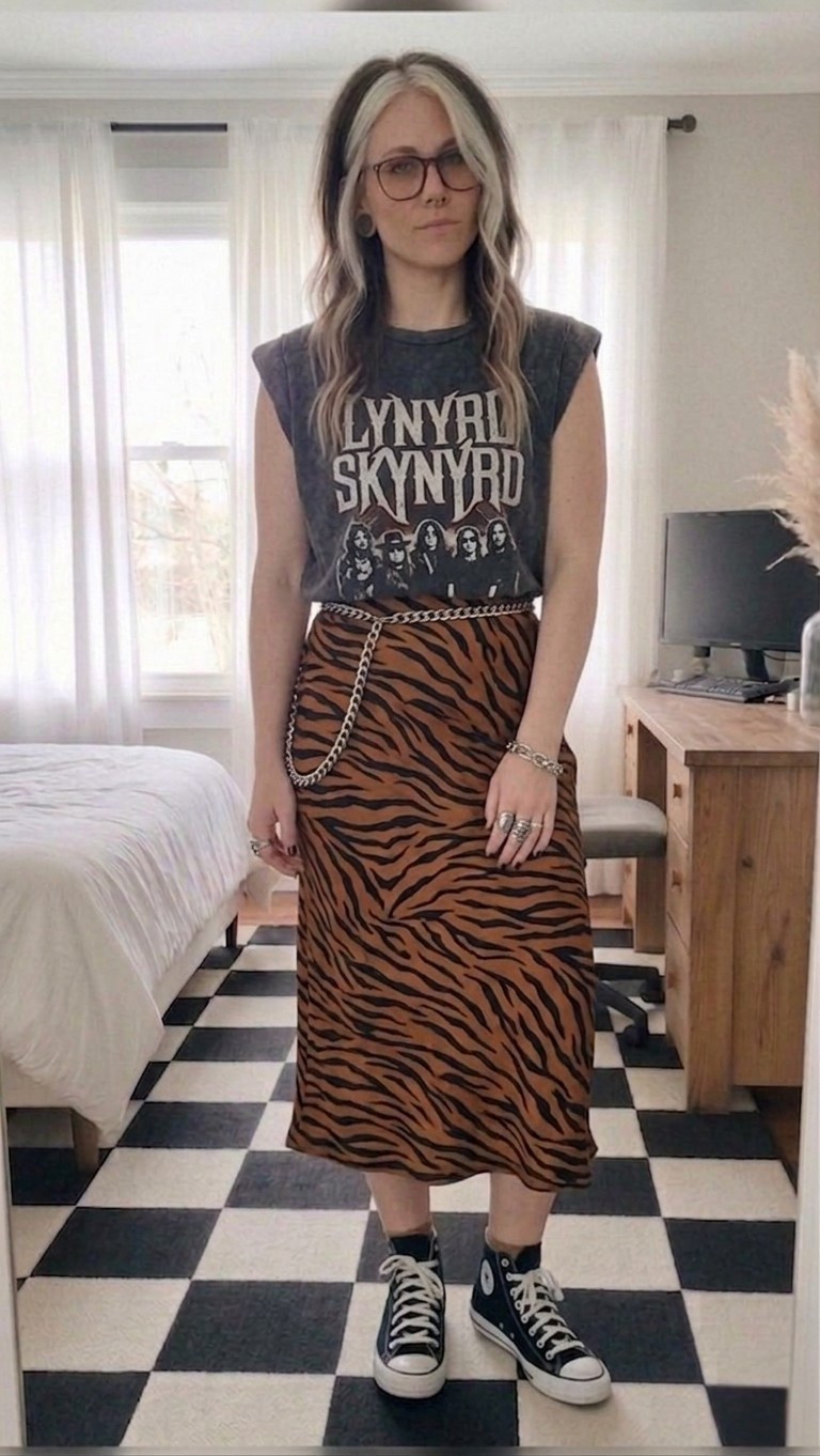Mixing prints and band tees is my favorite way to add some edge to a midi skirt! This Lynyrd Skynyrd muscle tee has that perfect worn-in vintage feel, paired with a high-waisted tiger print skirt for a silhouette that’s both flattering and bold. I finished the look with my go-to black high-top Chuck Taylors and a silver chain belt to pull the alt-vibe together.

Perfect for concerts, brunch with a bit of attitude, or just running errands in style.

#LTKootd #LTKMidsize #LTKSeasonal