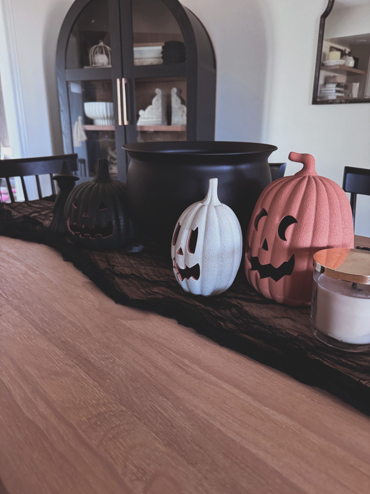 Dining table styled for spooky season 🎃🖤 These jack-o’-lanterns + the cauldron centerpiece make such an easy statement. Linking everything for a simple, chic Halloween look. #HomeDecor #HalloweenTable #LTKHome