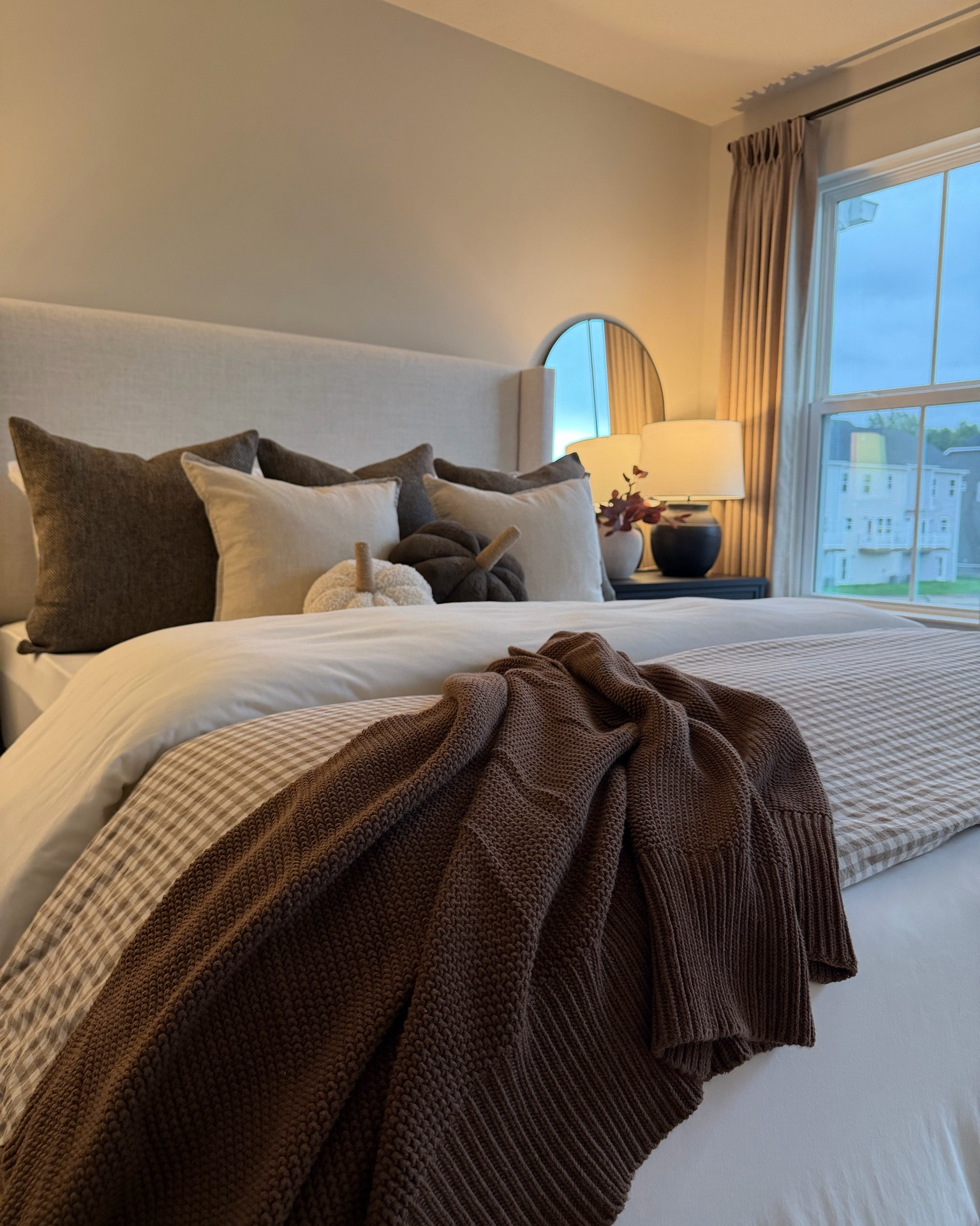 Guest room, bedroom styling, fall decor, gingham duvet, brown knit blanket, brown throw blanket, arch mirror, cream upholstered bed, pumpkin pillow, cream comforter, throw pillow

#LTKSaleAlert #LTKHome #LTKSeasonal