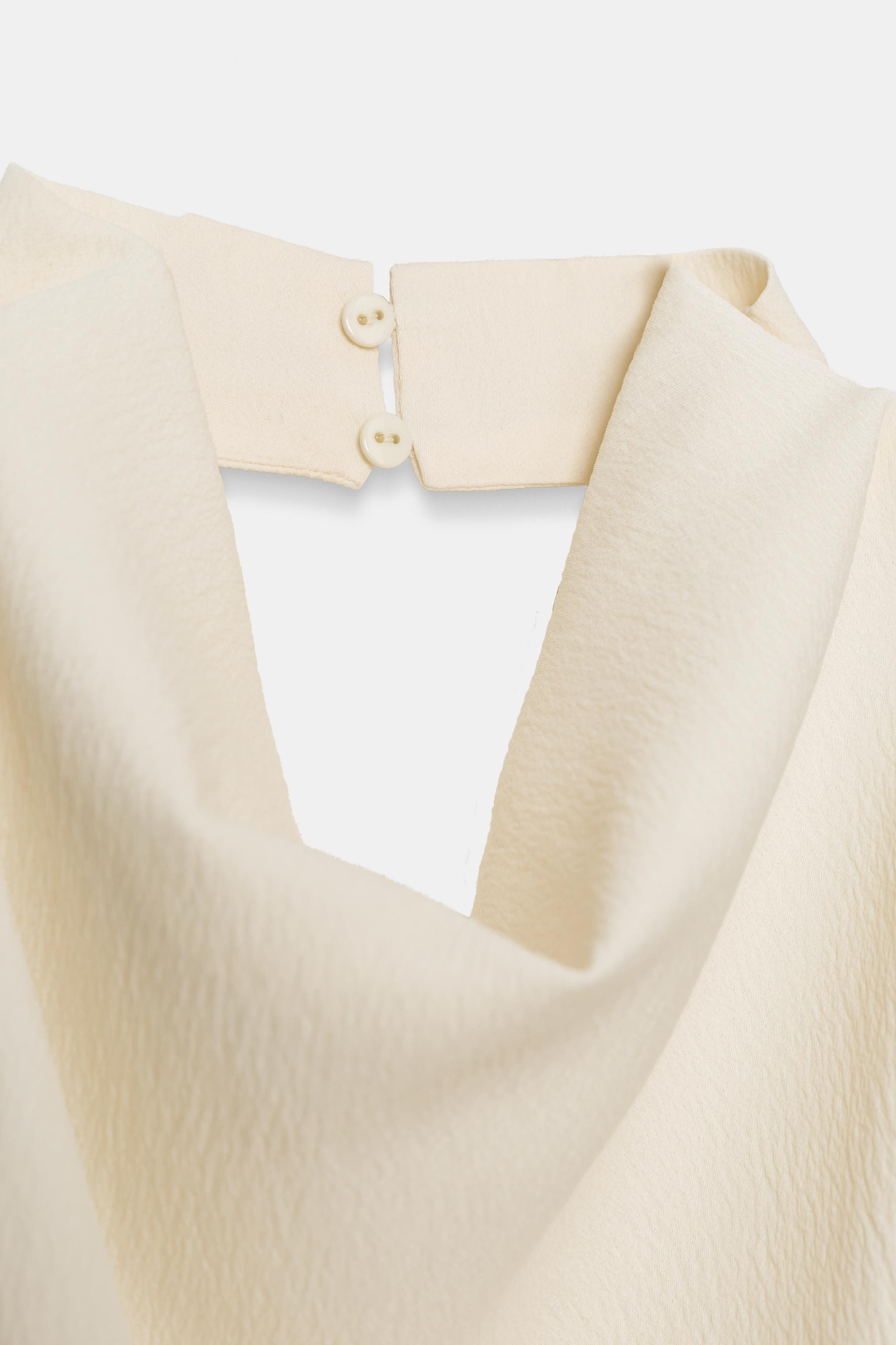 ZARA WOMAN COLLECTIONTop made with viscose. Draped halter neck. Open back. Asymmetric hem. Button... | Zara UK