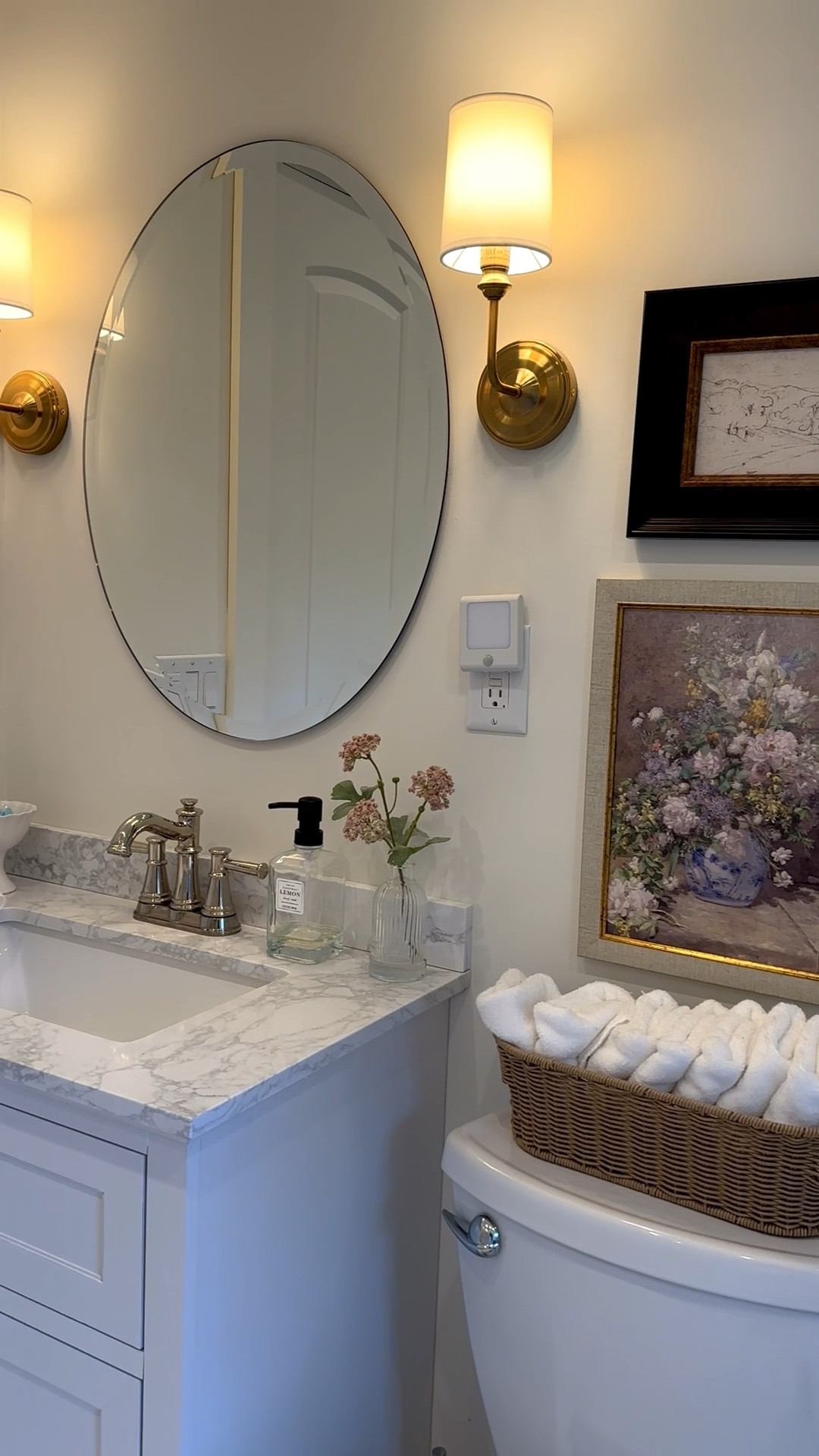 Primary bathroom, small white vanity, brass sconces, oval mirror, Nancy Meyers aesthetic 

#LTKHome #LTKStyleTip
