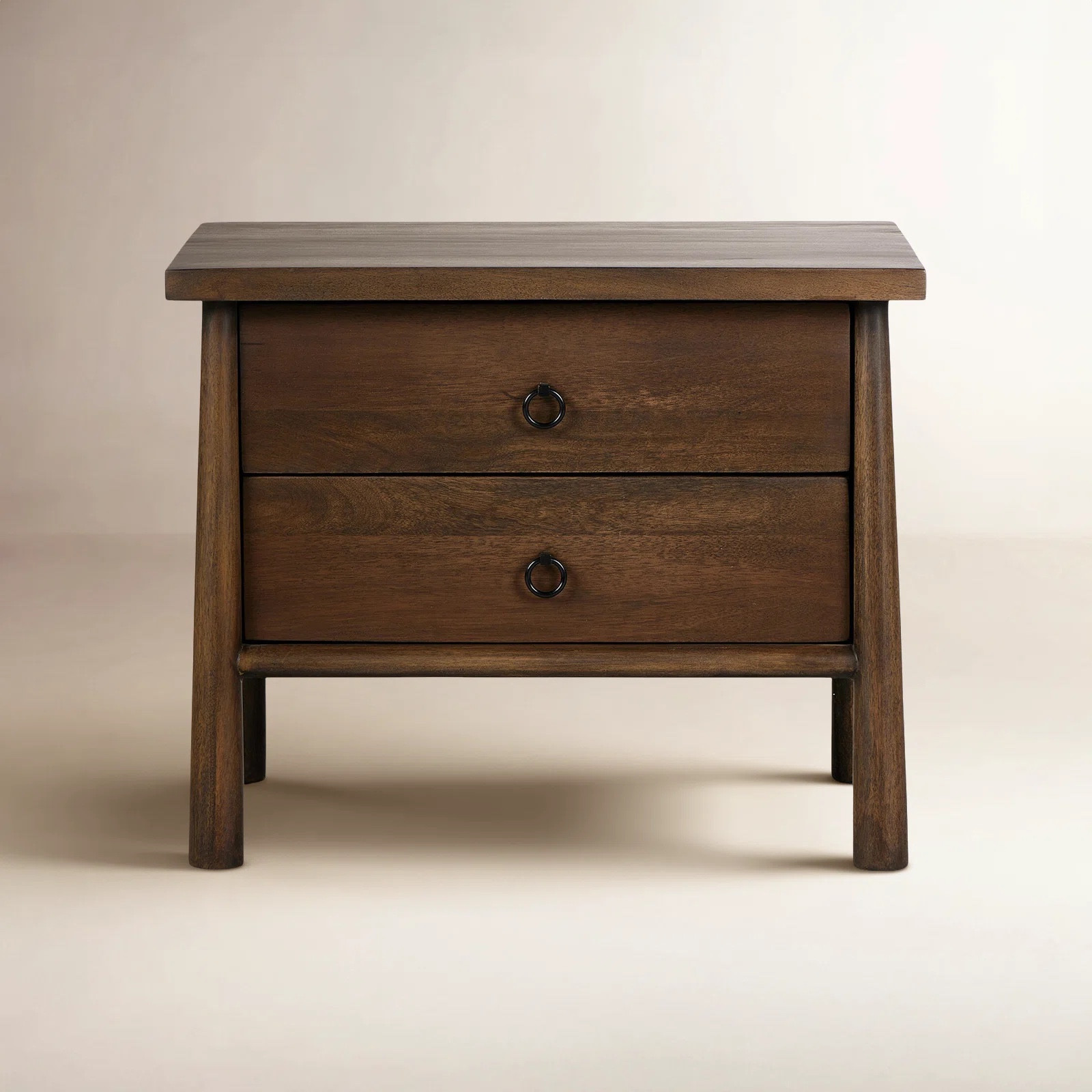 Inspired by French antique design, this dresser stands on round tapered legs with a prominent overhang top. Made of mango wood with cast iron key ring pulls, two drawers make it a versatile choice as a dresser or nightstand.

#LTKHome #LTKSeasonal