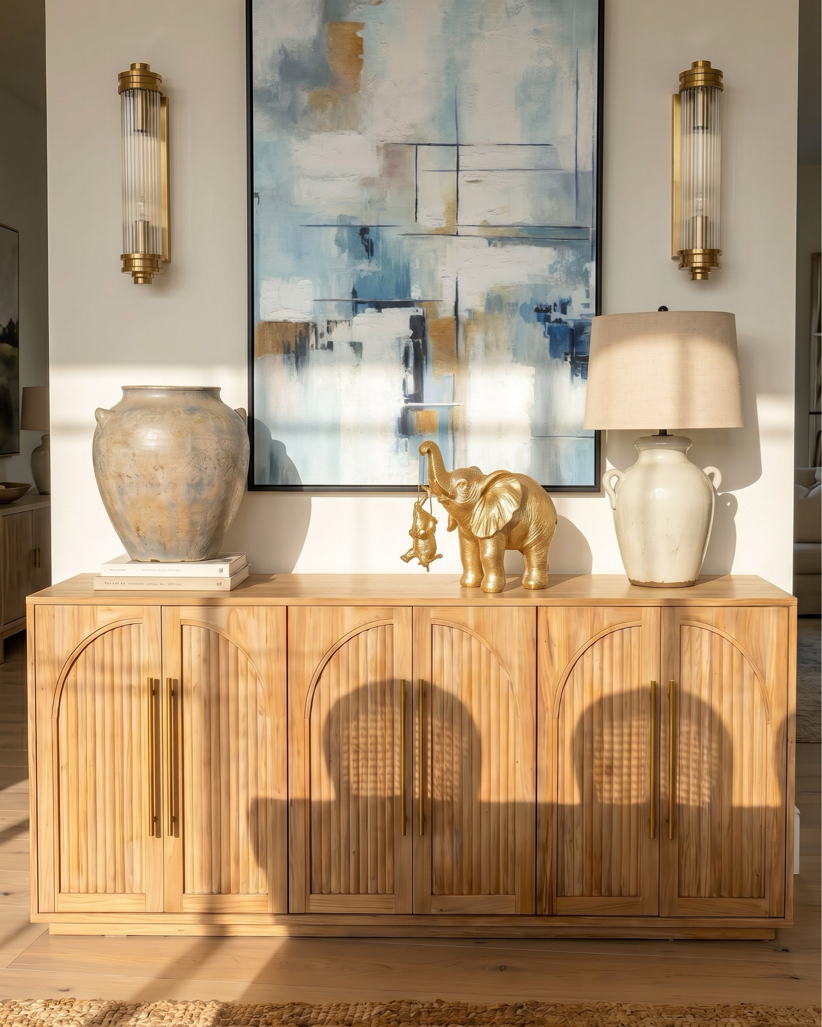 Oak wood extendable dining table
Wood cane dining chair
Beige jute rug
Wood oak console credenza 
White ceramic vase 
Distressed terracotta vase
Ceramic table lamp 
Brass gold decor figures 
Decor book 
Oak wood display cabinet 
Brass gold chandelier 
Glass brass wall sconce 
Blue subtract wall art 

#LTKHome #LTKSaleAlert