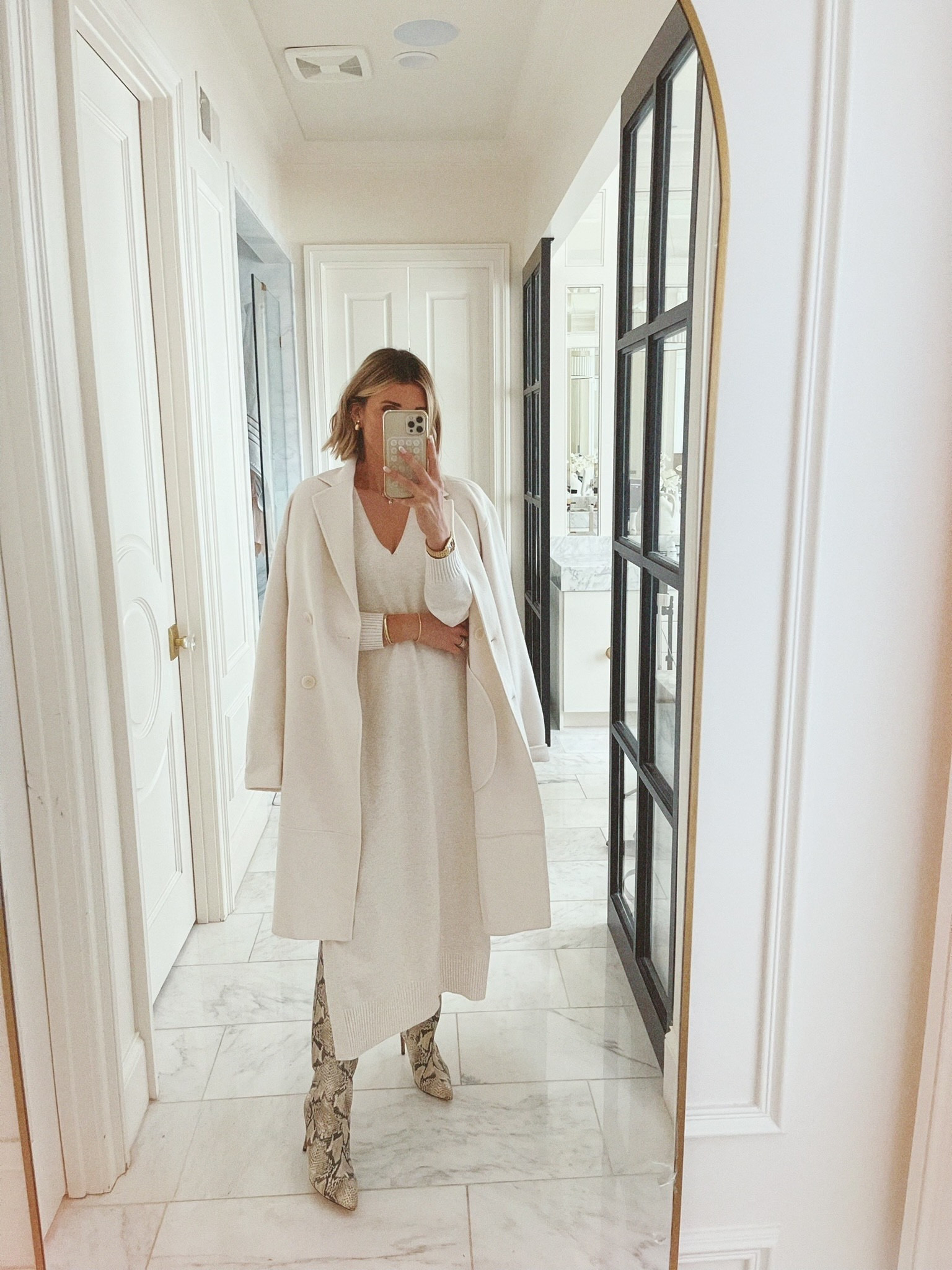 This monochrome look goes so well with a statement boot. 

#LTKSeasonal