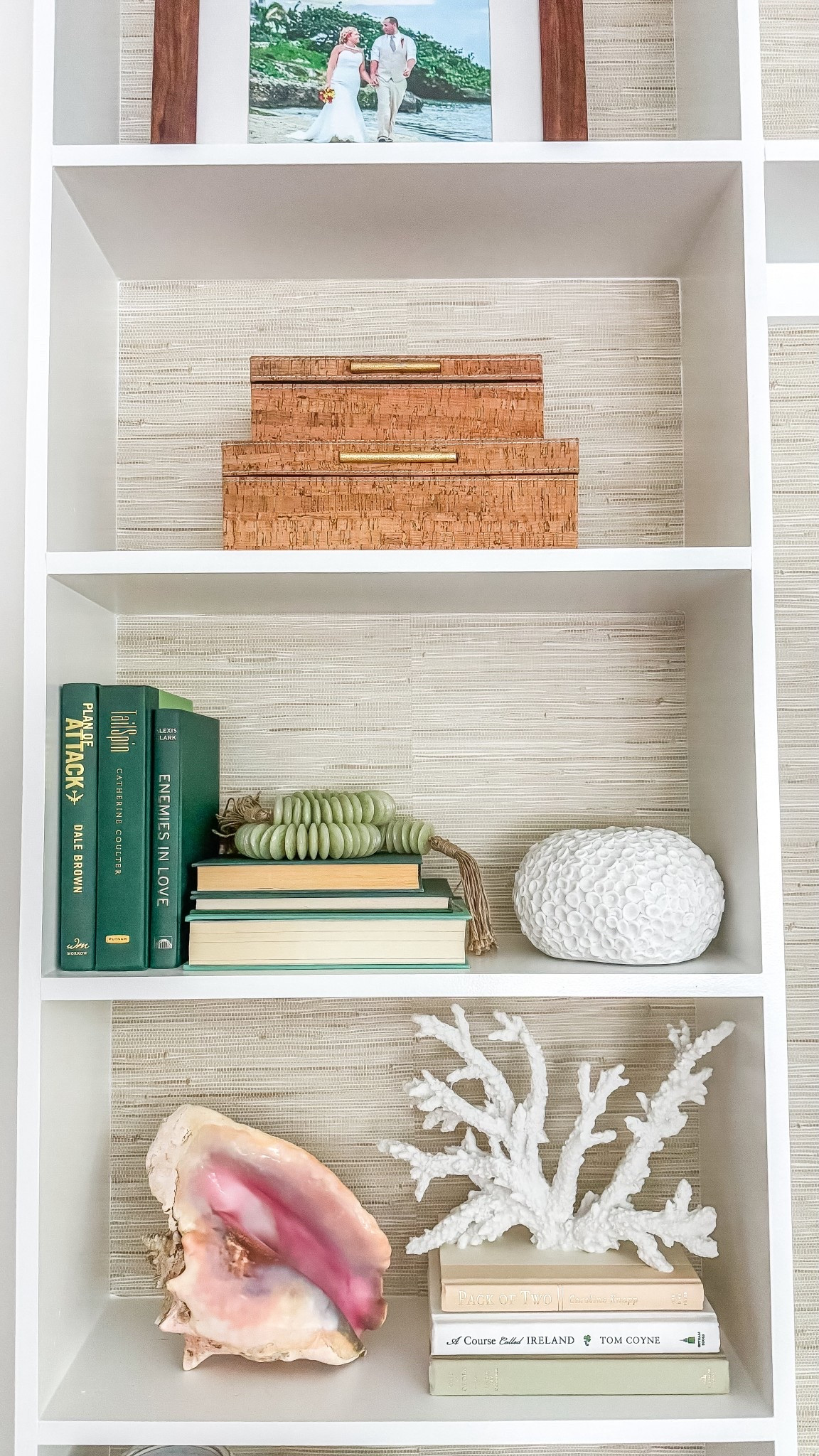 Coastal Grandmillennial shelf decor, books, coral, decorative boxes