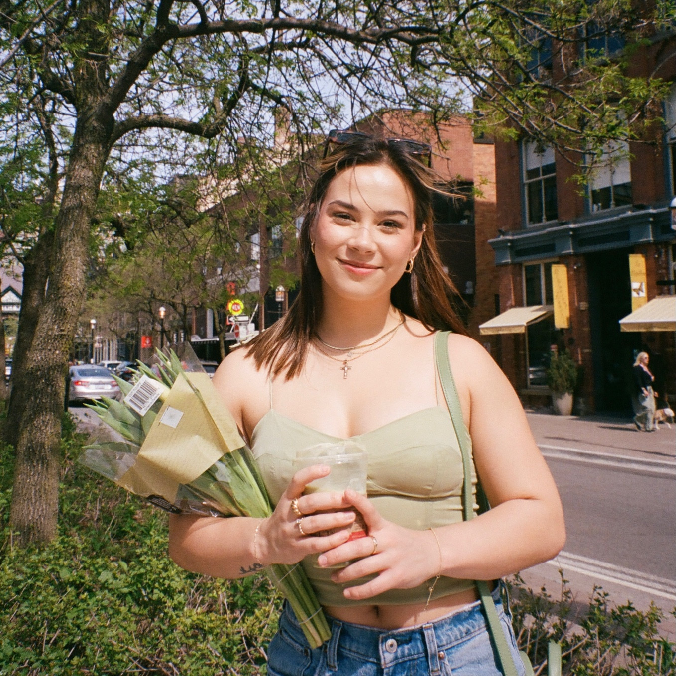 Sunny spring day out in the city 🌸 wearing a green tank top from oak and fort with Abercrombie curve love mid rise jeans, and oak and Fort sunglasses. 

#LTKSeasonal #LTKunder100 #LTKfit
