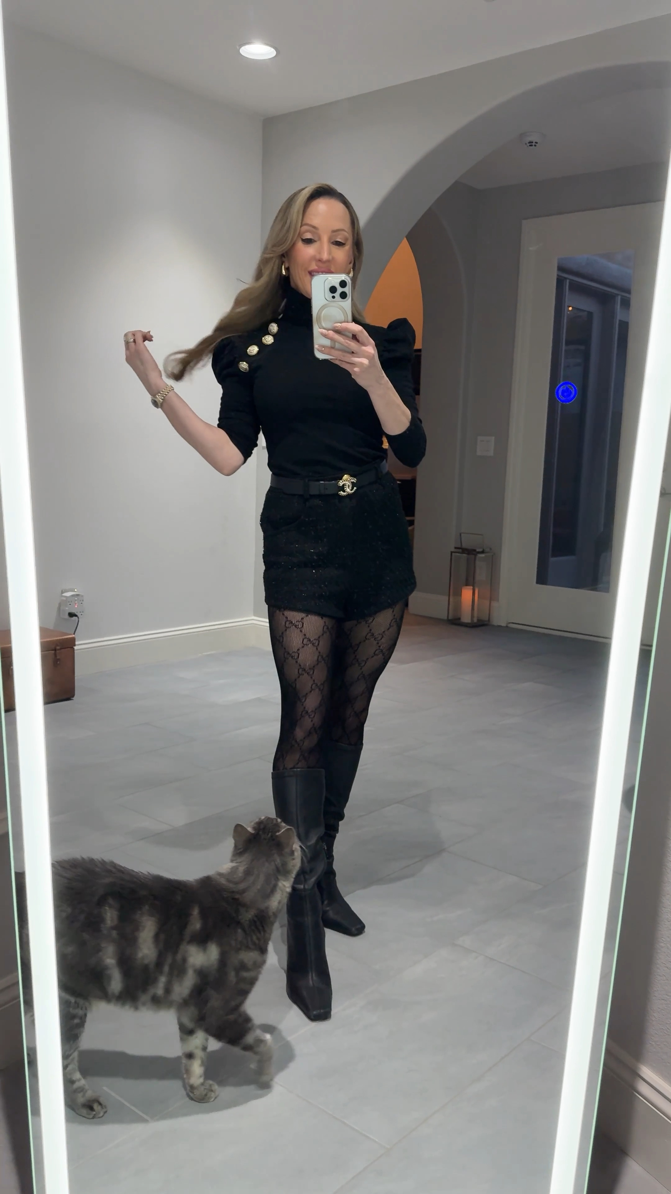 Winter outfit: black logo Gucci tights, black leather knee high boots, black tweed shorts, black roll neck sweater with gold buttons, crystal Chanel leather belt and chunky gold earrings. 

#LTKFindsUnder100 #LTKWatchNow #LTKStyleTip