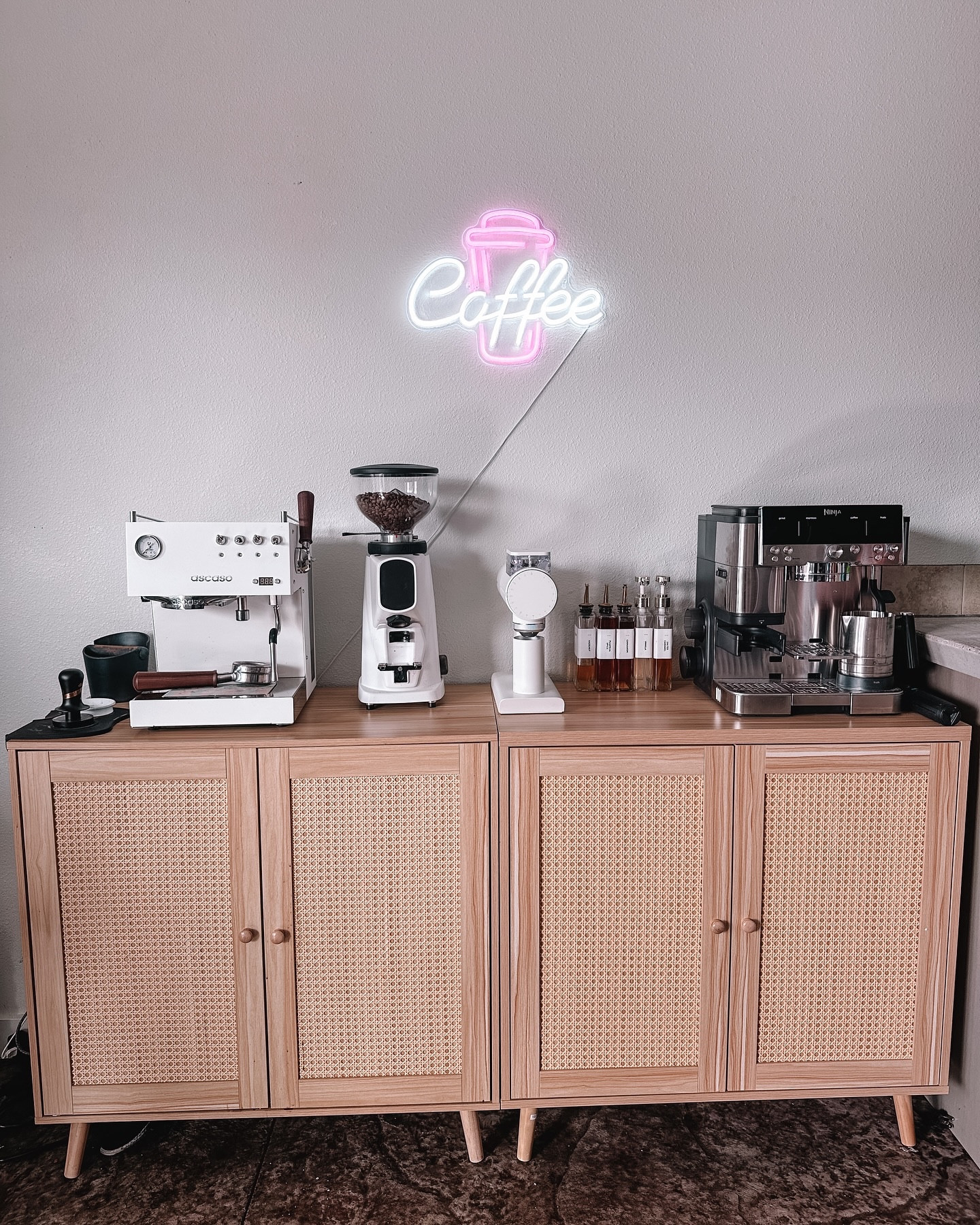 My coffee bar just got a major upgrade, and I’m officially obsessed! From the sleek machines to the dreamy neon glow, it’s giving coffee shop at home vibes. 💫

Now, every morning feels like I’m stepping into my own café – freshly ground beans, velvety espresso, and all the syrup options a barista could dream of. 🤎🫶

Who else romanticizes their morning coffee ritual? 🥹☕️ #CoffeeBarGoals #HomeCafeVibes #GoldenHourCoffee