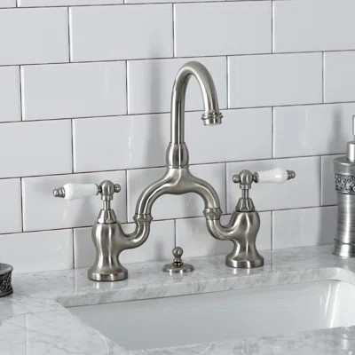 Kingston Brass English Country Two-Handle 3-Hole Deck Mount Bridge Bathroom Faucet with Brass Pop-Up | Wayfair North America