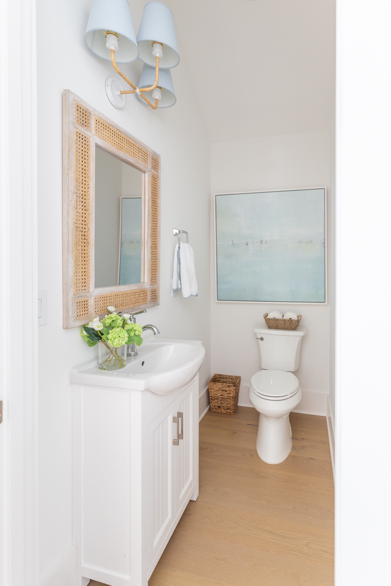 Our powder bath decorated for spring!Includes our rattan and blue linen bathroom light fixture, a small white vanity, cane mirror, scalloped hand towels, a seagrass wastebasket, and a cute floral arrangement in a glass vase! I’ll also link my favorite light blue brushstroke striped wallpaper I hope to use in the space! The art is old from One Kings Lane. See our full spring home tour here: https://lifeonvirginiastreet.com/2024-spring-home-tour/.
.
#ltkhome #ltksalealert #ltkseasonal #ltkfindsunder50 #ltkfindsunder100 #ltkstyletip spring decorating ideas, powder bath decor ideas, grandmillennial decor, coastal decorating

#LTKSeasonal #LTKsalealert #LTKhome