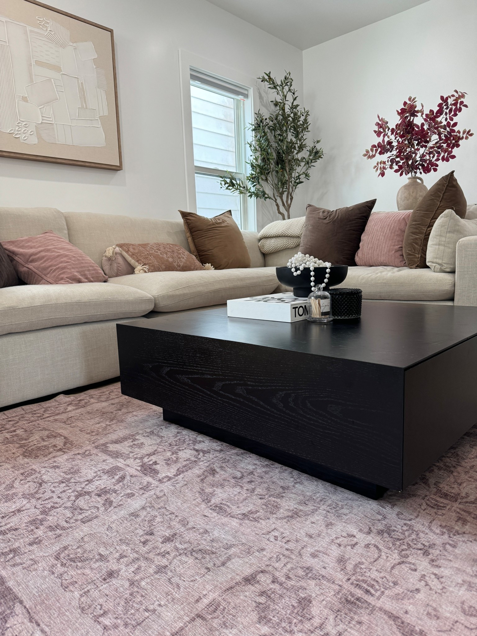 Neutral Living Room with Beige Sectional & Black Coffee Table

Soft neutrals done right 🤍 This cozy yet elevated living room features a beige sectional layered with blush and brown throw pillows, a bold black square coffee table, textured decor, and subtle greenery. Perfect inspiration for anyone loving neutral home decor, modern cozy vibes, and warm minimalist interiors. Ideal for apartment living, small spaces, or timeless home styling ideas.
Keywords ♥️

neutral living room
beige sectional sofa
neutral home decor
cozy living room ideas
modern neutral interior
apartment living room decor
warm minimalist home
black coffee table decor
neutral color palette
soft neutral aesthetic
living room styling ideas
modern cozy living room


#LTKSaleAlert #LTKSeasonal #LTKHome
