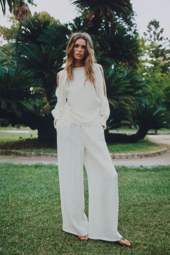 Round neck blouse with long sleeves featuring gathered cuffs and pearl-style buttons. Features sl... | Zara US