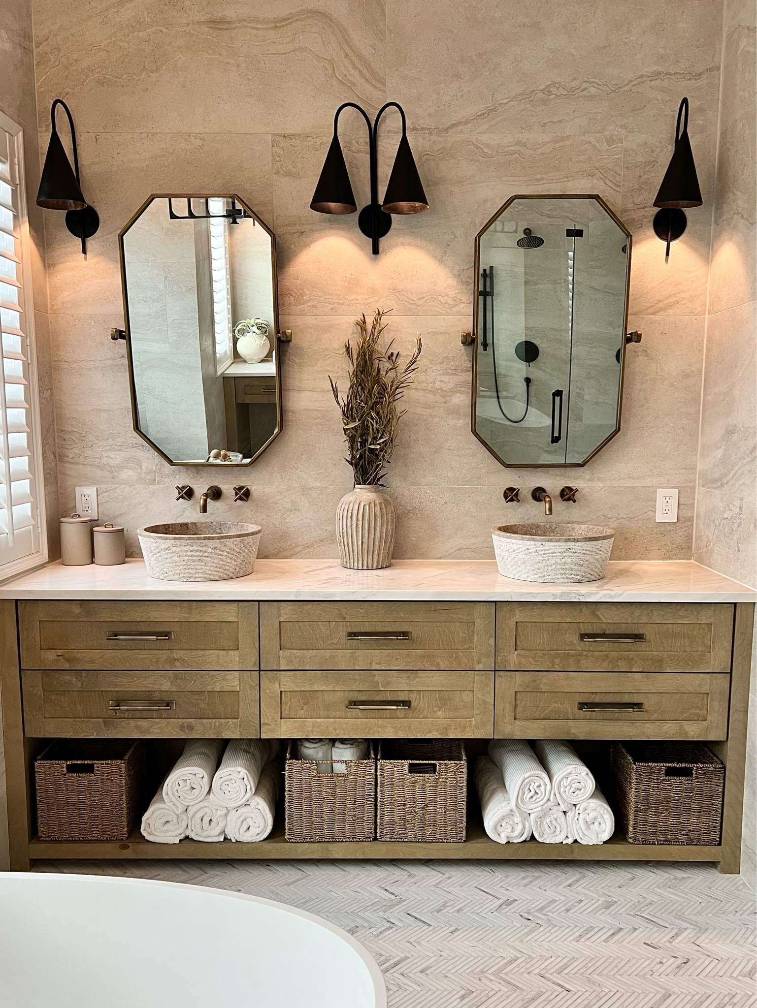 When you get ready in your bathroom but aren’t ever ready to leave. I’m obsessed with these natural stone sinks. It gives it that spa feeling, along with the rolled towels! Also fun, I mixed metals. So the sconces and shower hardware is all matte black but the sink faucet and drawer hardware is antique brass. Don’t be afraid to mix it up, makes your primary bathroom feel more custom!

#LTKFind #LTKbeauty #LTKhome