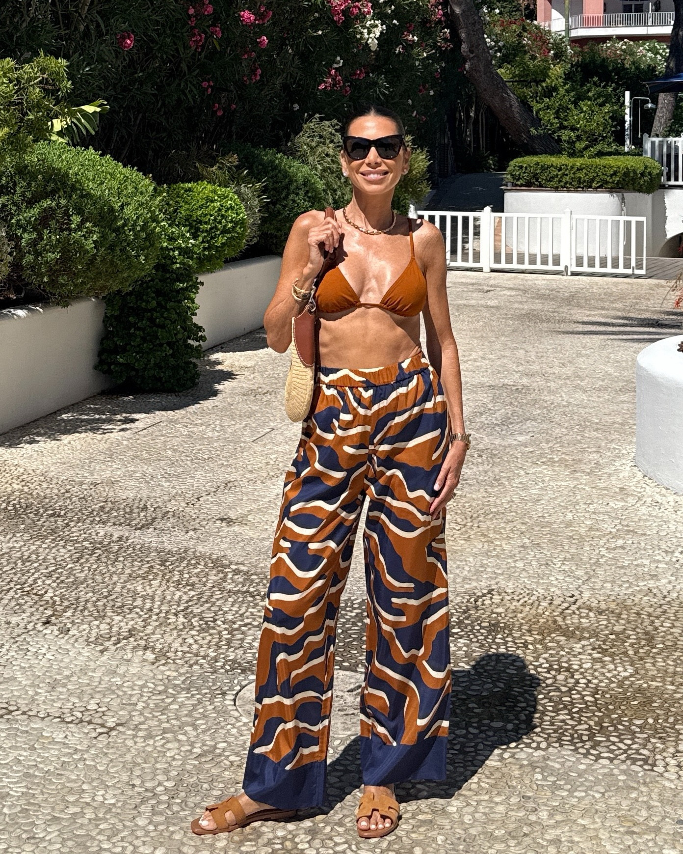 Coastal tones and flowing silhouettes 🌊☀️
Wearing the Atoll trousers in the Continent print—made from silk and cotton voile, inspired by the marks waves leave behind. Lightweight, relaxed, and spring-ready with an elasticated waist and pockets (always a plus). Paired with the matching Caramelo-colored swimsuit and my favorite woven bag from a past season—sadly sold out, but I’ve linked similar styles on LTK.
#CapriDays #BeachToLunch