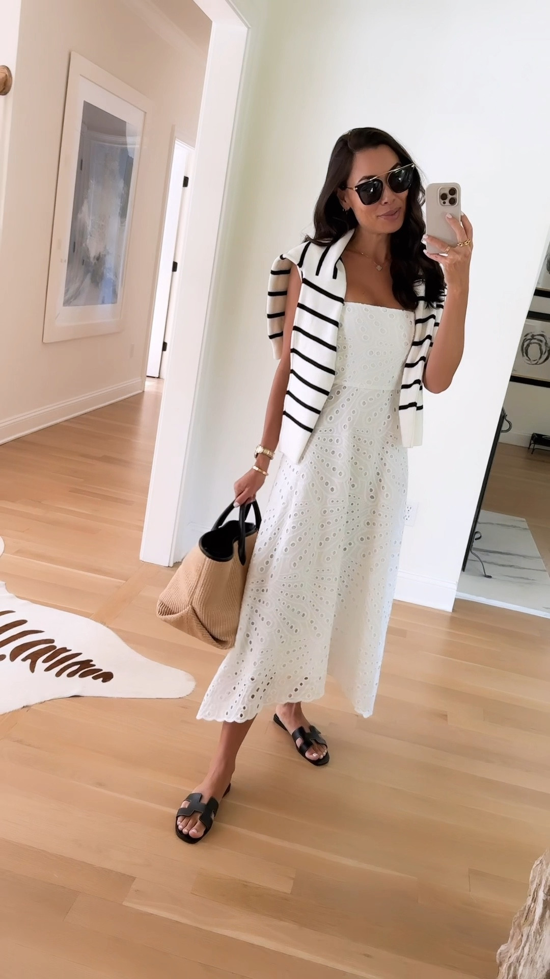 Kat Jamieson wears an Everyone Loves The Weekend dress. Use code LTK15 for 15% off! 

If in between sizes, you could size down. I typically wear an XS/S and got an XS. 

Summer outfit, eyelet, white dress, stripe sweater, Hermes sandals, Khaite tote, raffia bag, classic style. 

#LTKSaleAlert #LTKShoeCrush #LTKSeasonal