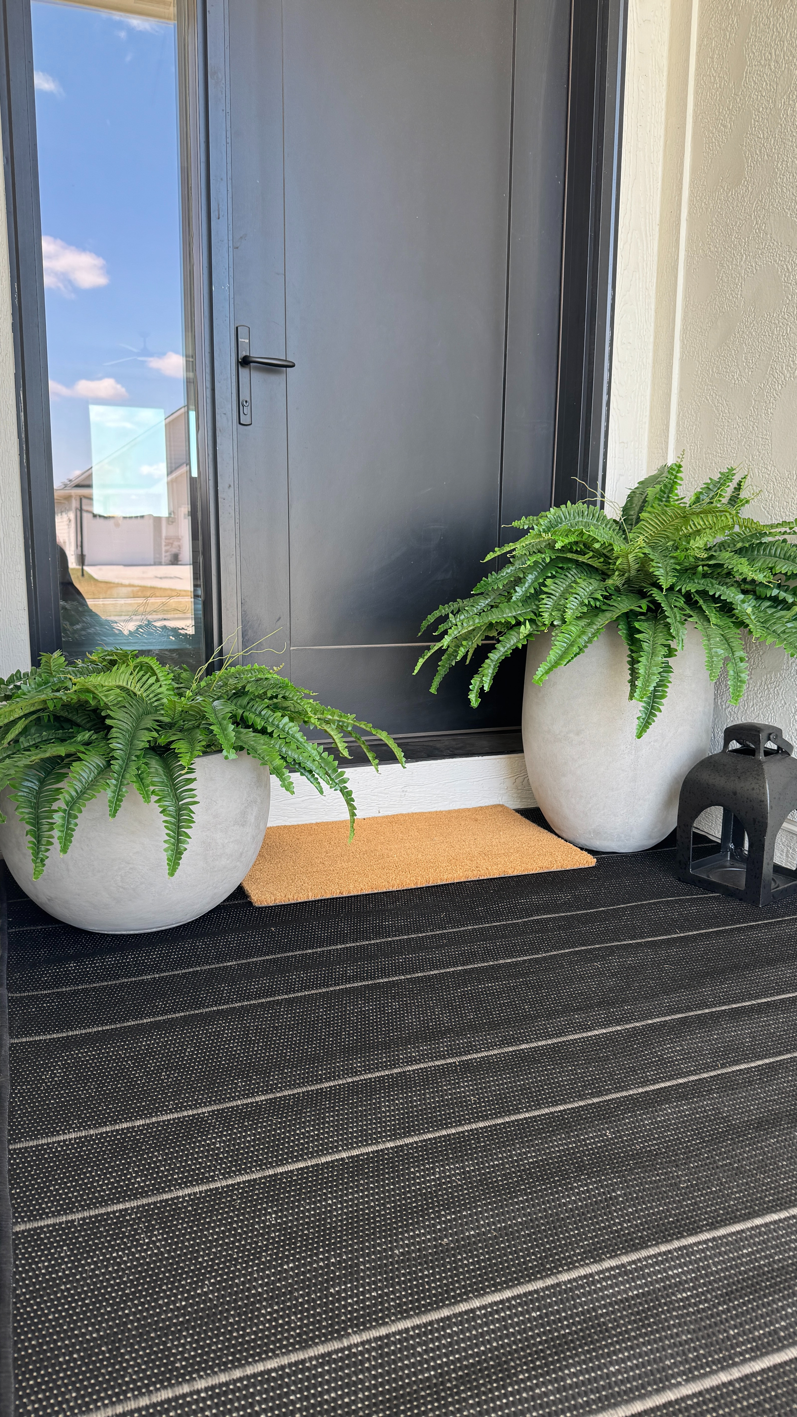 Simple and neutral front porch decor 🤍 Such an easy way to make the entry feel warm and welcoming with ferns, planters and a neutral rug. 

 #LTKHome