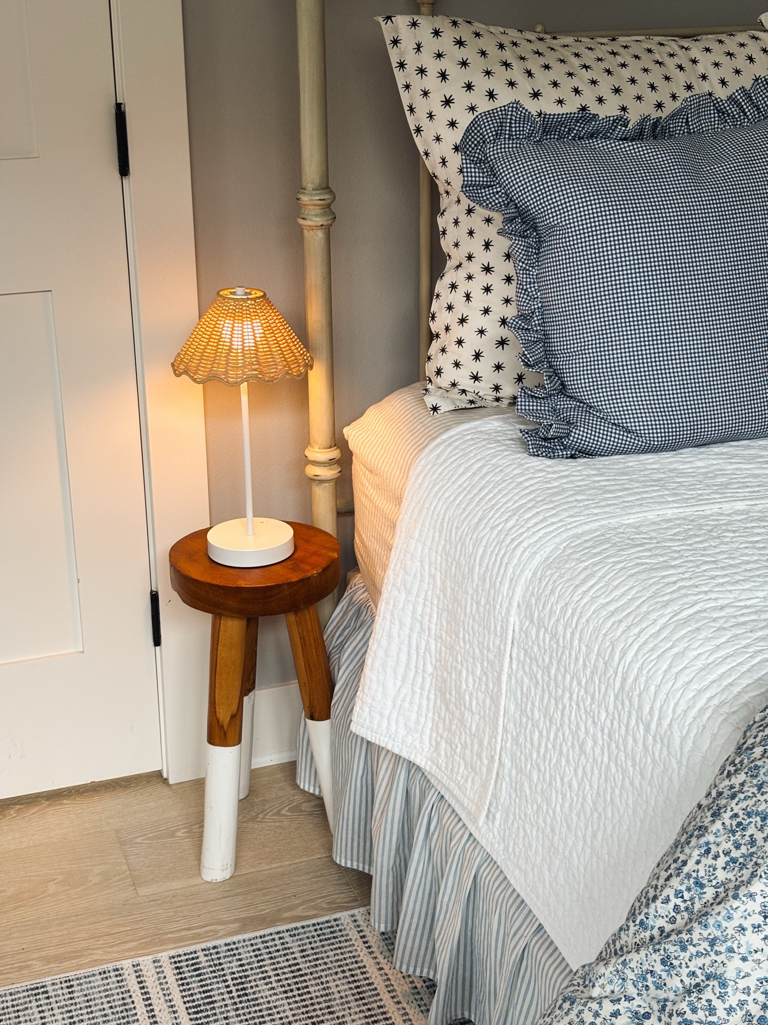 Sources in our Snug - Cordless rattan shade lamp, wood stool (tiny space nightstand!), mini check ruffle pillows, bedding, blue and white striped rug

#LTKHome #LTKSeasonal #LTKSaleAlert