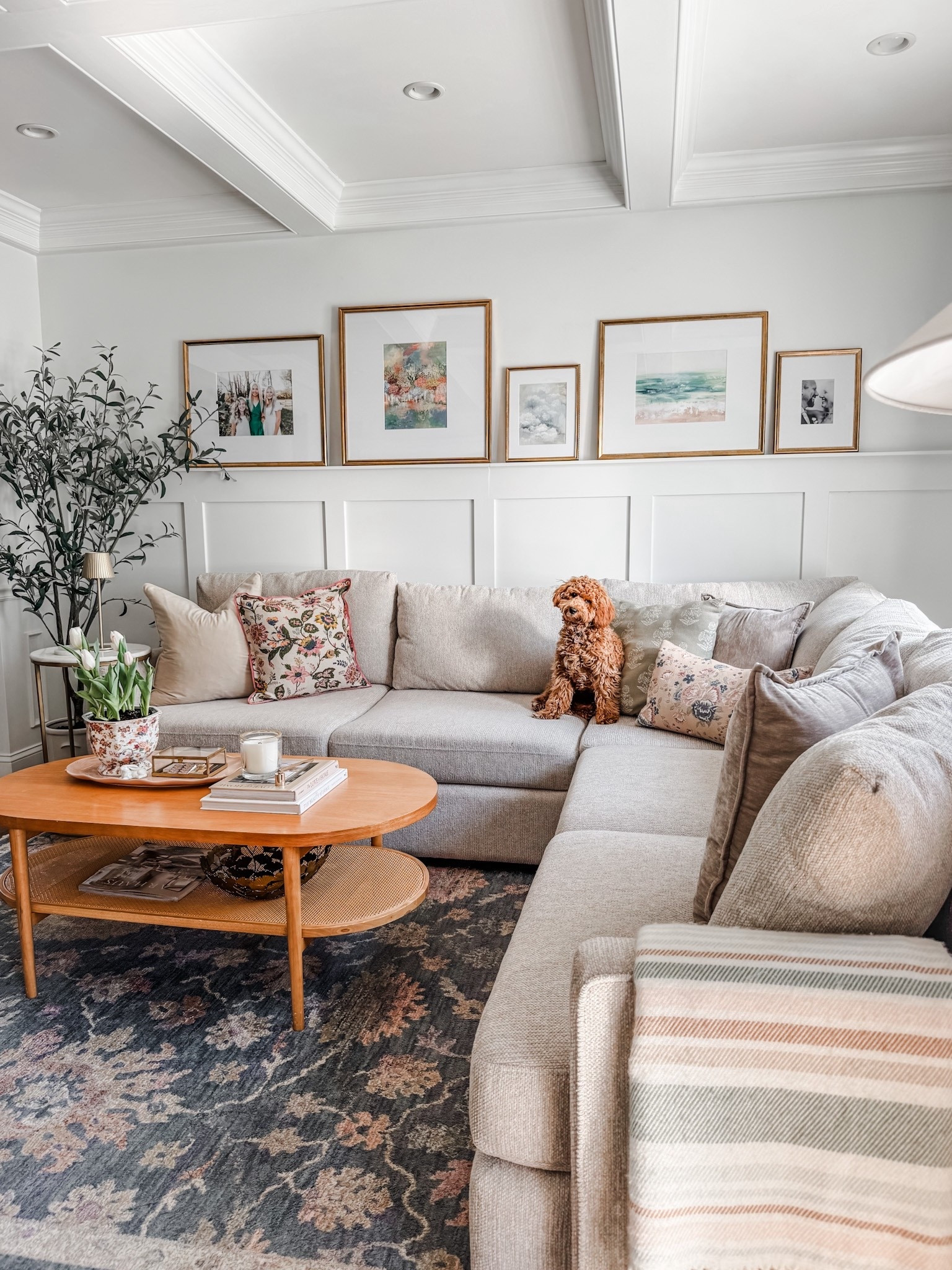 Living room decor
Spring decor
Spring coffee table decor
Olive tree
Blue area rug
Oval coffee table
Rattan coffee table
Spring art print 
Gallery wall