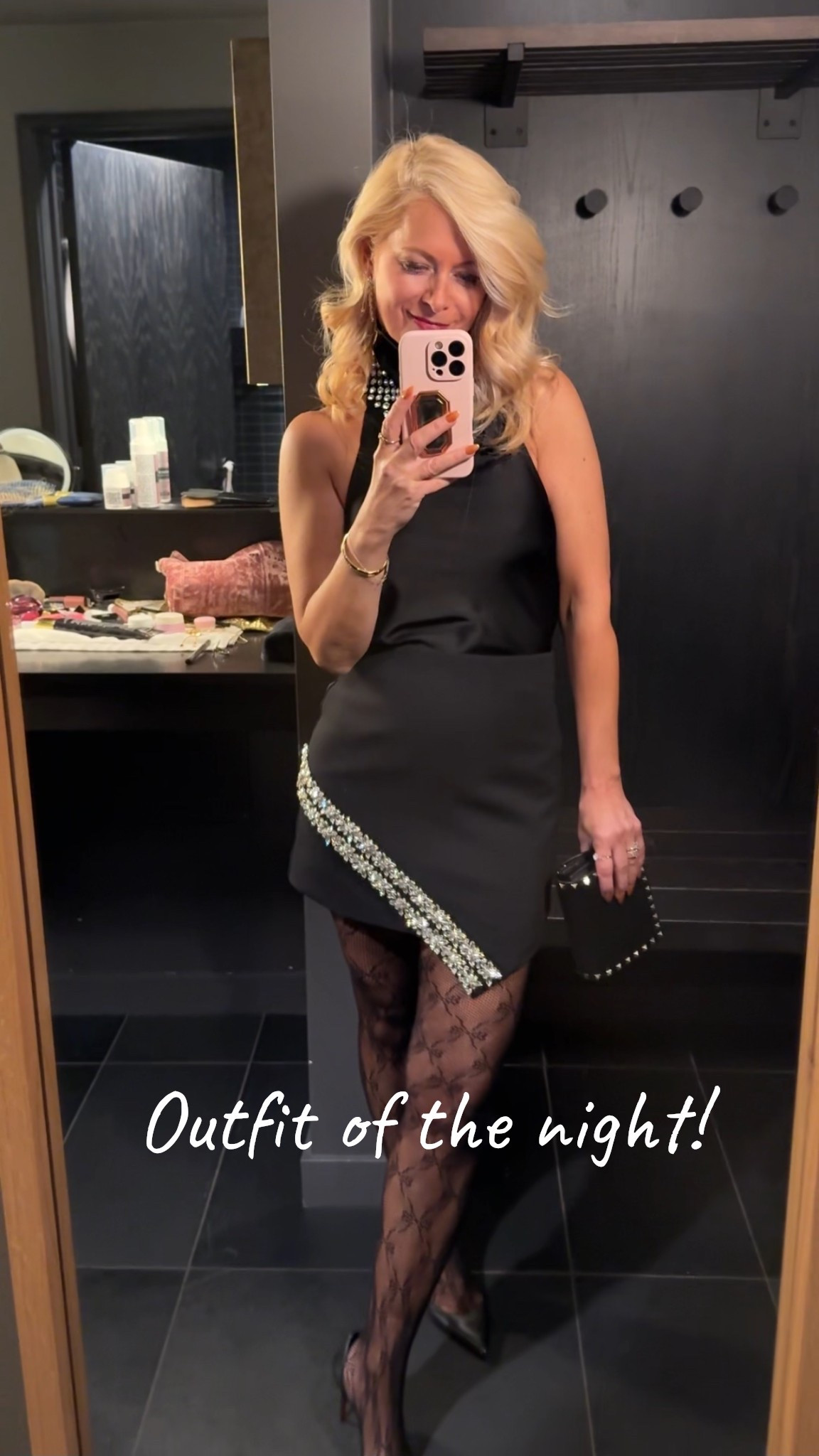 All black outfit of the night! 

Black silk halter top, black asymmetrical gem mini skirt, black stud clutch, pattern tights and heels 

#LTKootd #LTKPetite #LTKOver40