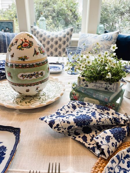 Easter tablescape decor - floral tiered egg (compartments for candy inside!), book planter, blue and white napkins, tablecloth 

#LTKhome #LTKstyletip #LTKparties