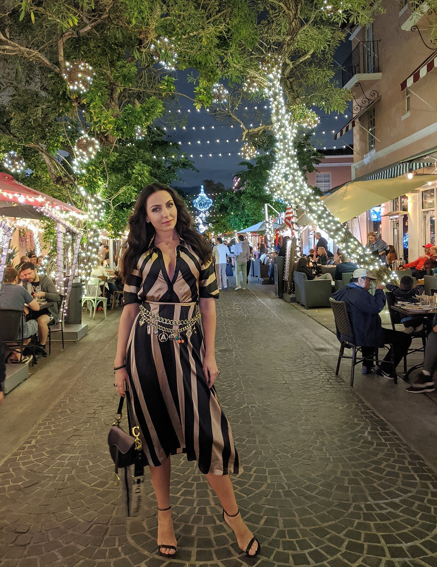Twinkling lights and the perfect night-out look! This striped midi dress paired with a statement chain belt is the ultimate sophisticated style for dinner and drinks. Ready for any celebration! Tap to shop this head-turning outfit and accessories! #NightOutOutfit #StatementBelt #MidiDress #ChicStyle #OOTN #ShopTheLook #VacationStyle #FashionInspo 

 #LTKHoliday #LTKdayinmylife #LTKootd