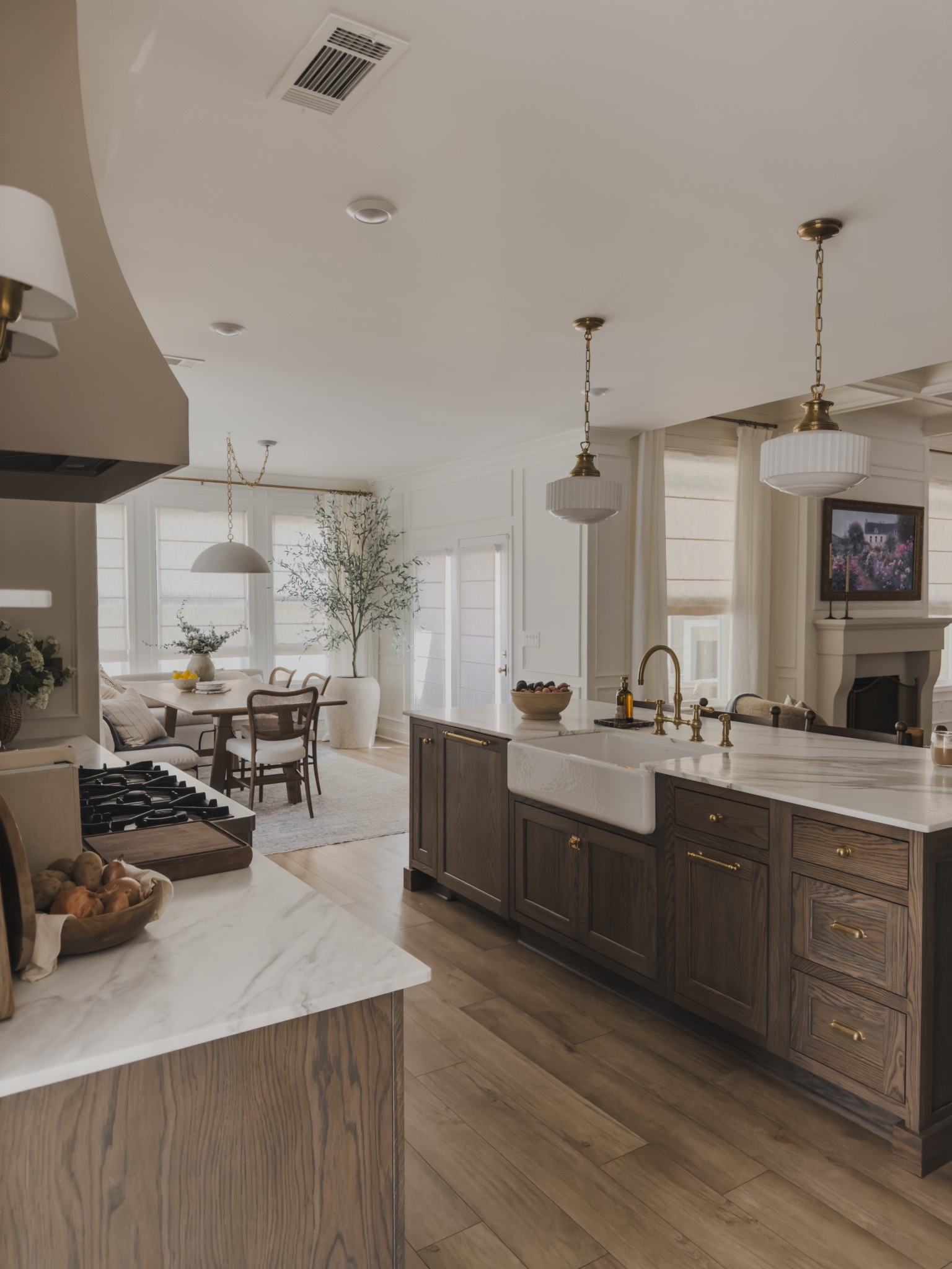 Kitchen views leading into the breakfast nook and living room! Open concept spaces designed for timeless living and accents that transition well through each season and year.

Home finds, neutral home inspo, collected style, timeless home inspo, spring refresh, rich wood tones, furniture favorites, neutral wood tones, vintage style area rug, farmhouse style sink, brass detail, pendant lighting, breakfast nook, faux florals, linen curtain, roman shades, swag light, Pottery Barn style, Wayfair, Visual Comfort, McGee and Co, Rejuvenation, Arhaus, Loloi, Amber Lewis, shop the look!

#LTKSeasonal #LTKHome