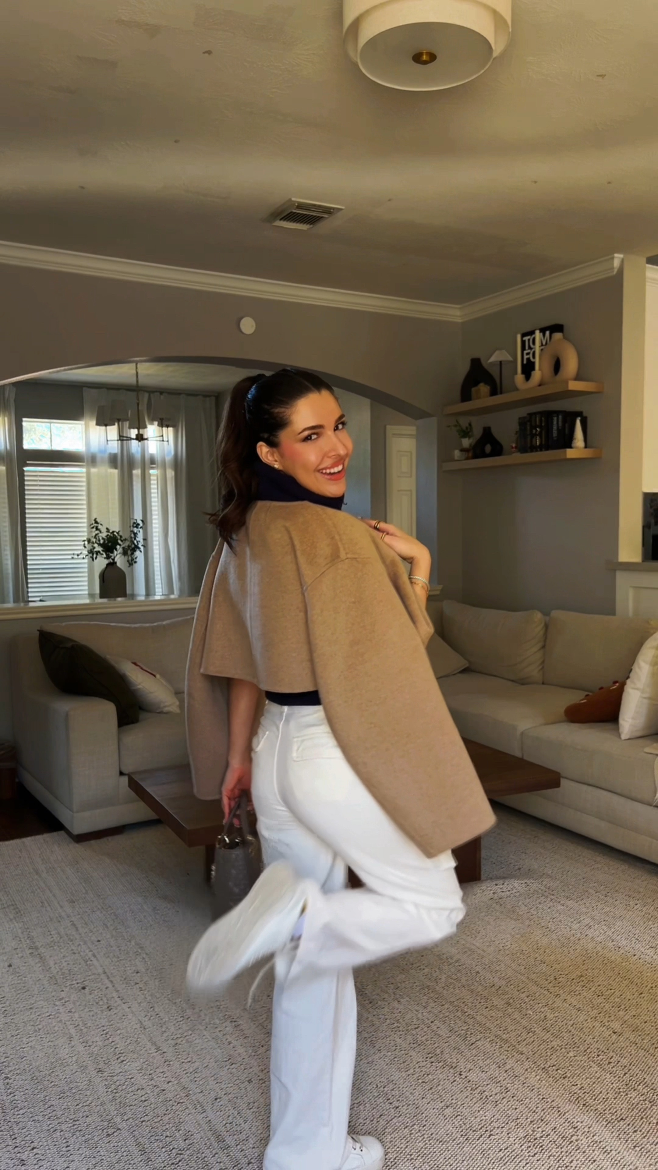 Casual spring outfit details - cargo white pants, sleeveless navy turtleneck, cropped tan jacket, white sneakers 

#LTKStyleTip