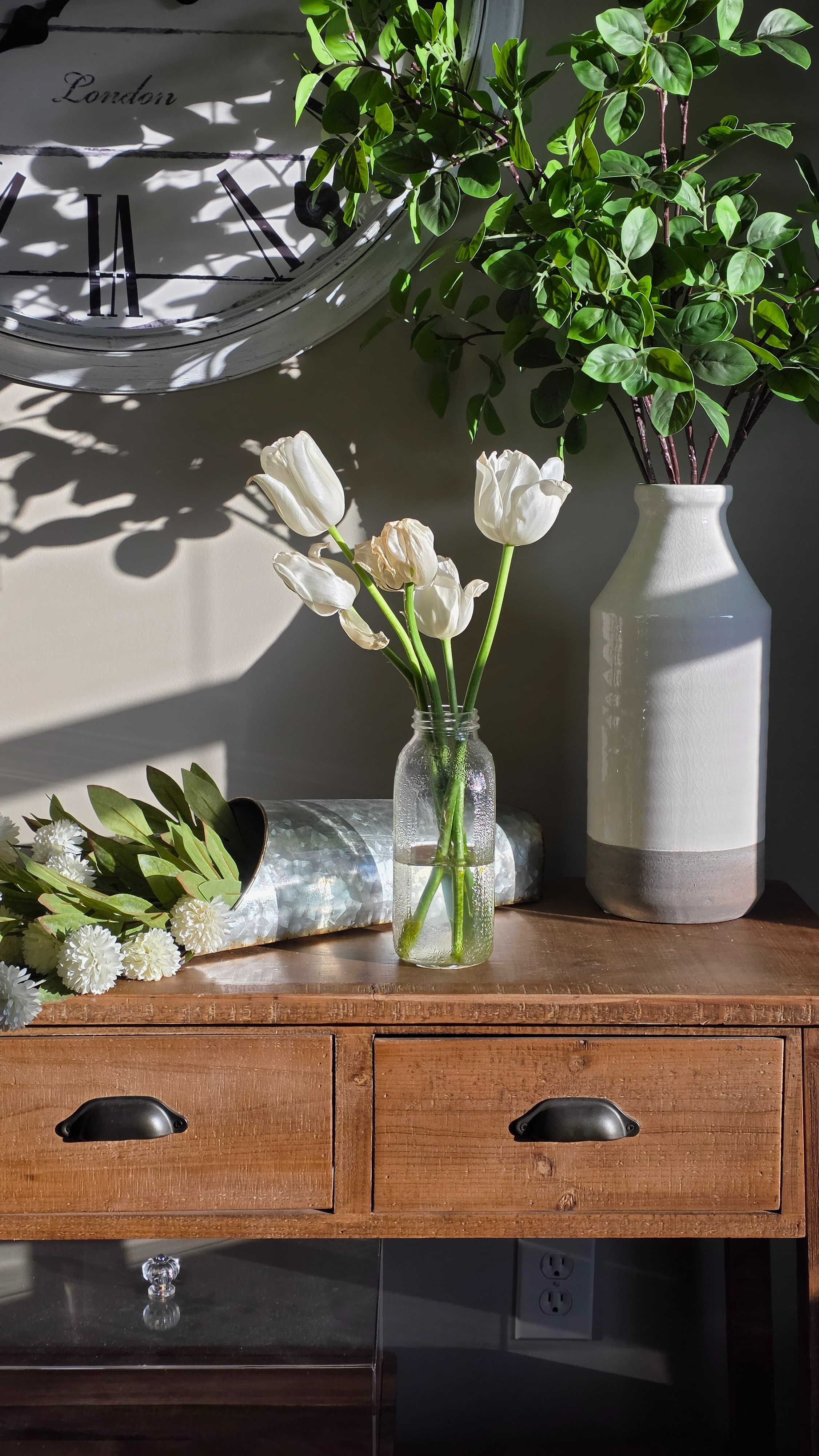 Neutral farmhouse entryway decor you can copy 🤍Rustic wood console table styled with tulips, ceramic vase, greenery stems, and a vintage wall clock for that clean modern farmhouse look. Simple, affordable pieces that instantly elevate your space.Shop this console table decor, neutral home accents, spring styling, and farmhouse decor finds all in one place.#LTKHome #LTKFinds #farmhousedecor #neutralhome #entrywaydecor #springdecor #consoledecor #modernfarmhouse

#LTKSeasonal #LTKHome #LTKmorningroutine