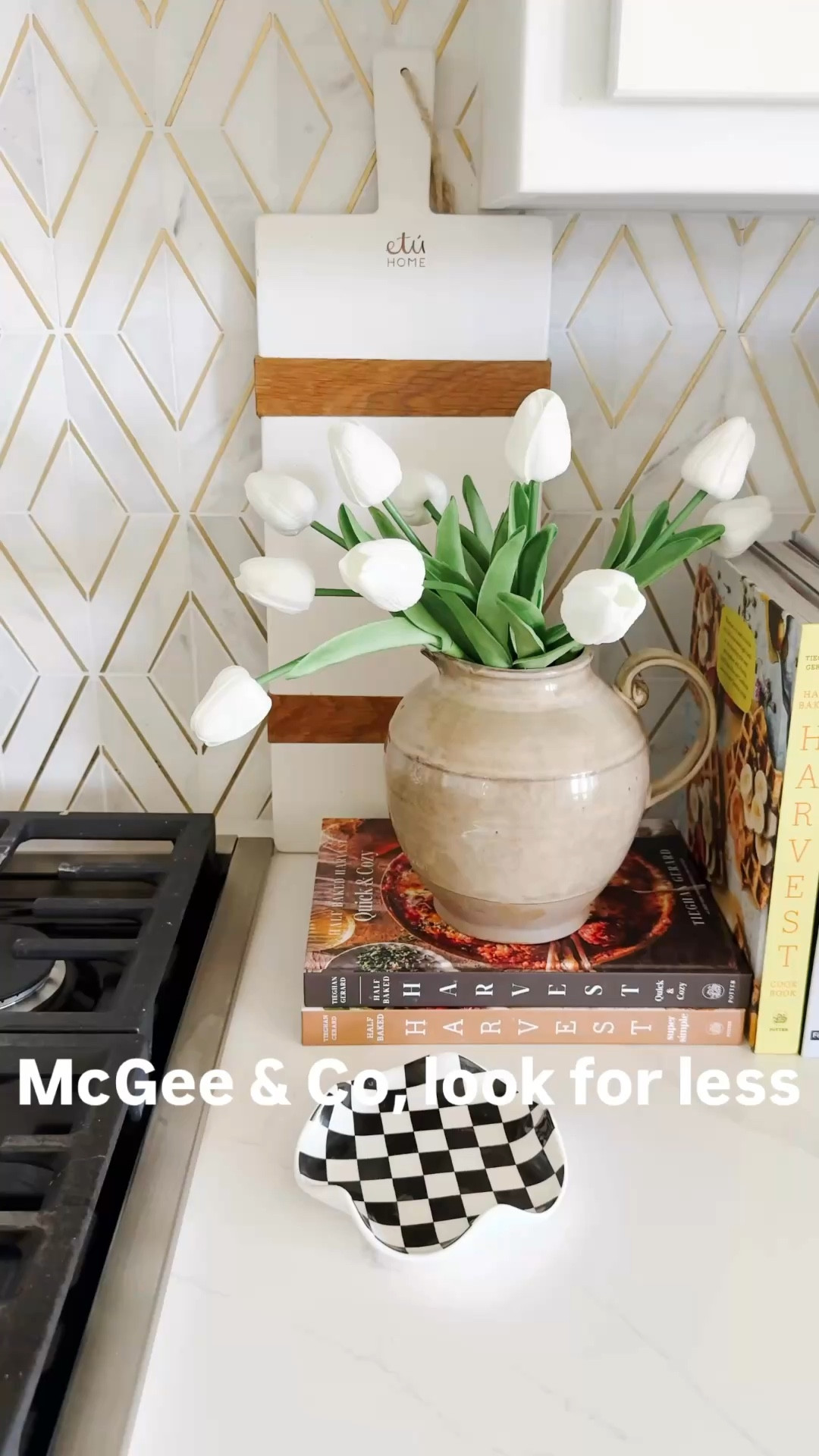 McGee & Co inspired kitchen styling using a mix of high-end and affordable finds to recreate that warm, layered look for less. I styled this neutral kitchen corner with a ceramic vase, faux tulips, stacked cookbooks, and a wood pedestal for that collected, elevated feel without the designer price tag. If you love Studio McGee style, these pieces give the same aesthetic with budget-friendly options you can actually mix into your home. Love a good designer look for less while mixing in a few investment timeless pieces. Follow me on LTK for daily home decor, styling ideas, and affordable finds that look high-end.

#LTKHome #LTKSaleAlert