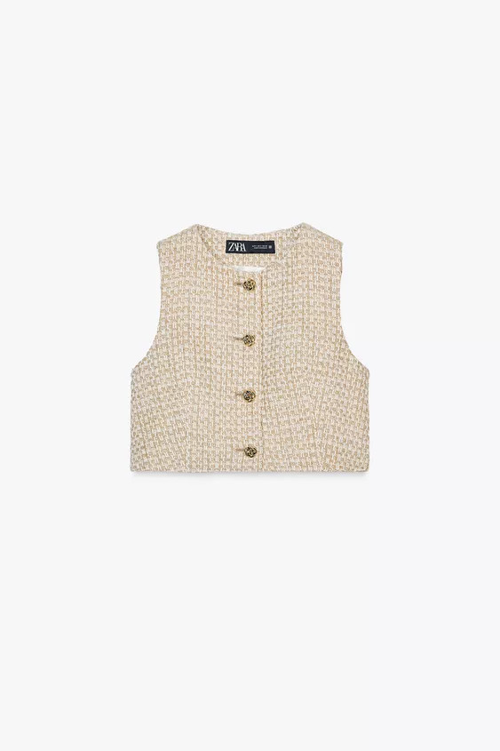 Sleeveless round neck waistcoat. Metallic yarn fabric. Front fastening with raised gold buttons. | Zara UK